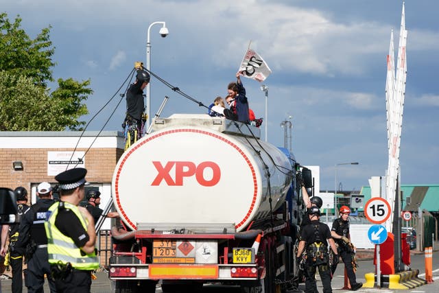 Police prepare to remove protesters from This Is Rigged as they sit on top of an oil tanker at the Ineos refinery in Grangemouth, Fife (Jane Barlow/PA)