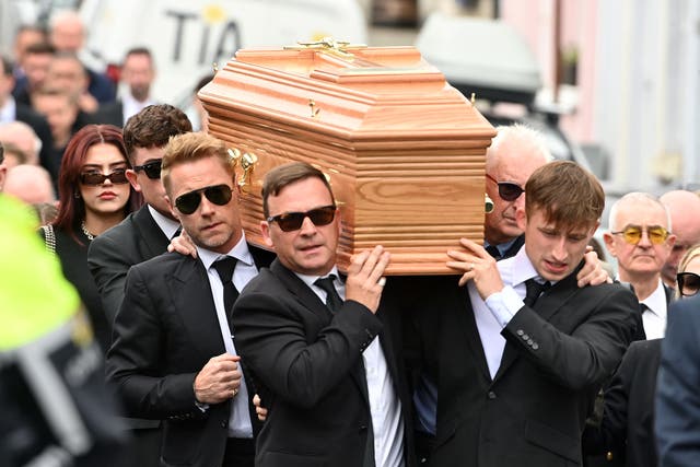 <p>Ronan Keating (centre middle left) helps carry the coffin of his brother Ciaran Keating towards St Patrick’s Church in Louisburgh, Co Mayo, for his funeral. The older brother of Ronan Keating died in a two-car crash near Swinford in Co Mayo (Oliver McVeigh/PA)</p>