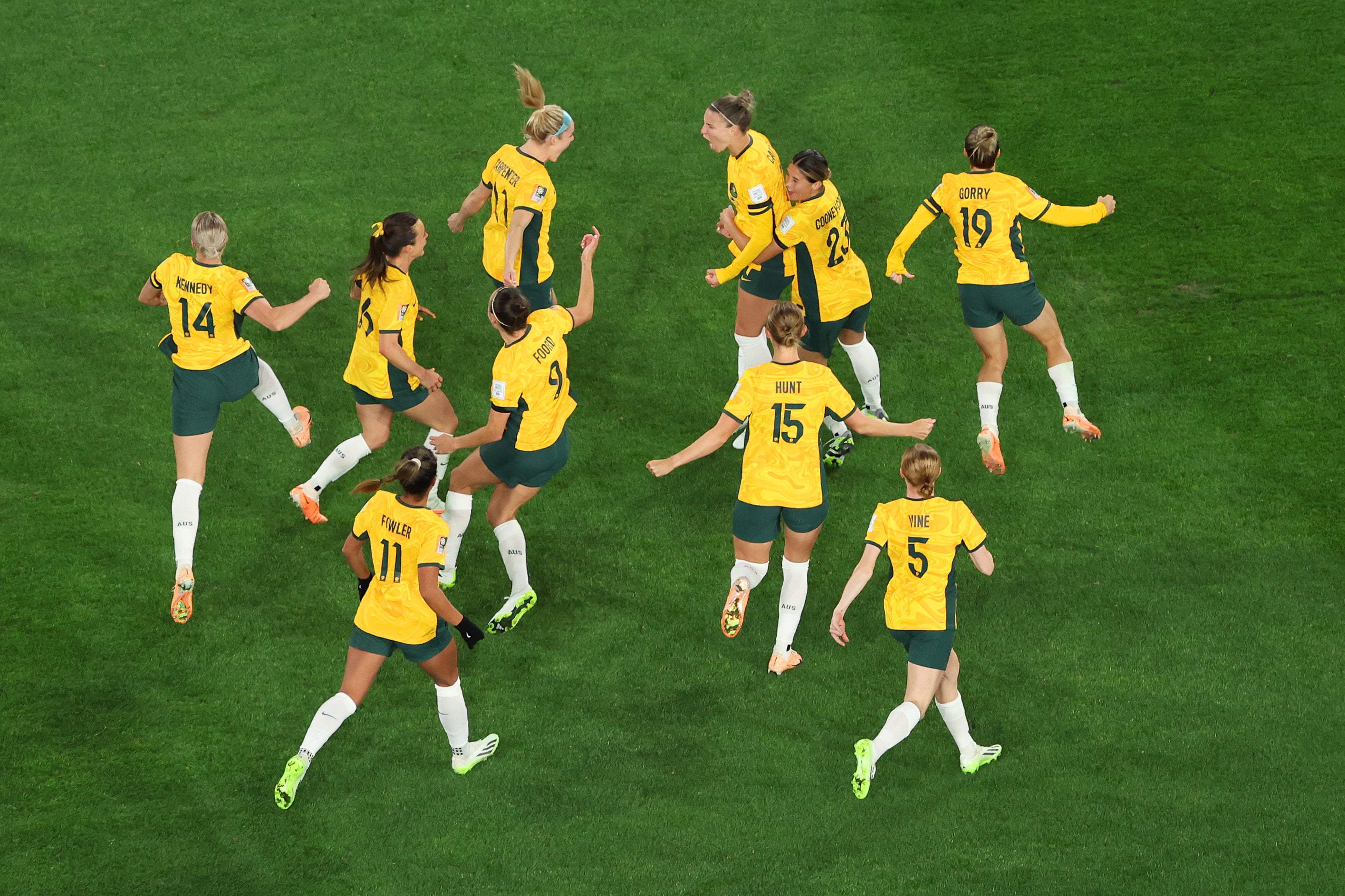 Steph Catley (3rd R, top) of Australia celebrates with teammates after scoring her team's first goal