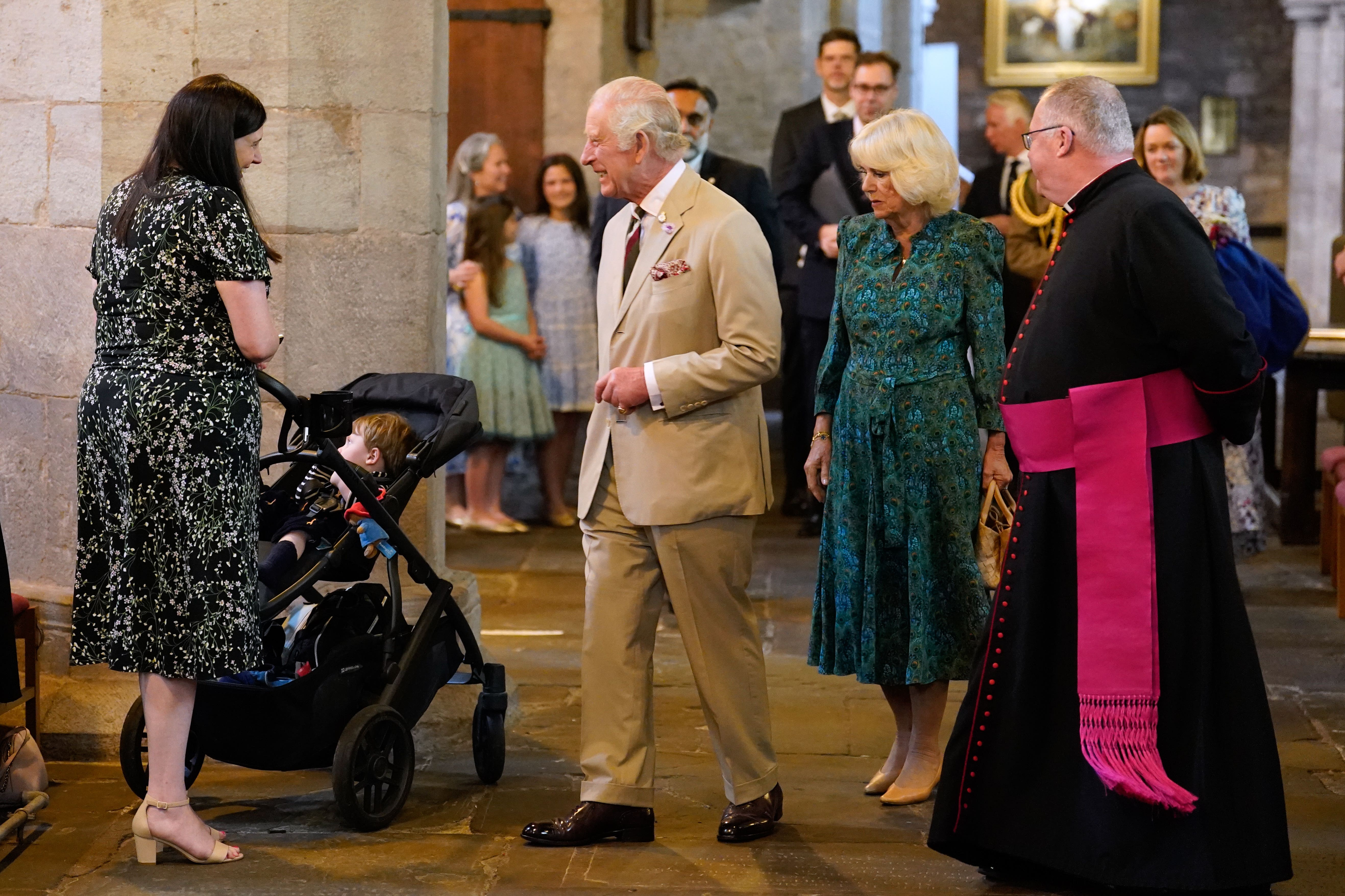 Charles and Camilla meet Melissa Davies (left) and her son Rupert during a visit to Brecon Cathedral (Andrew Matthews/PA)