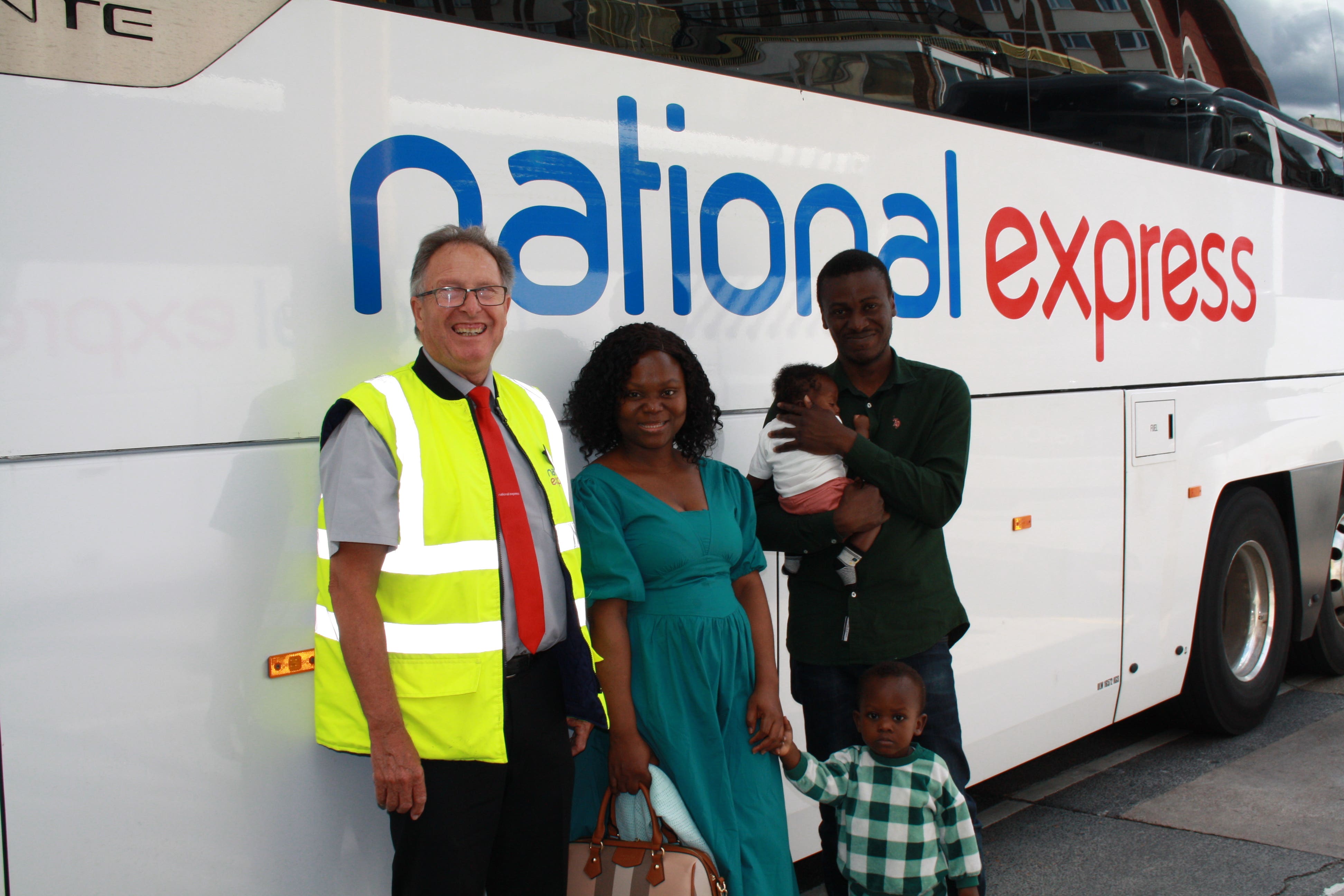 Adepeju Opayemi with her husband and two sons with coach driver Tony Boswell (National Express/PA)