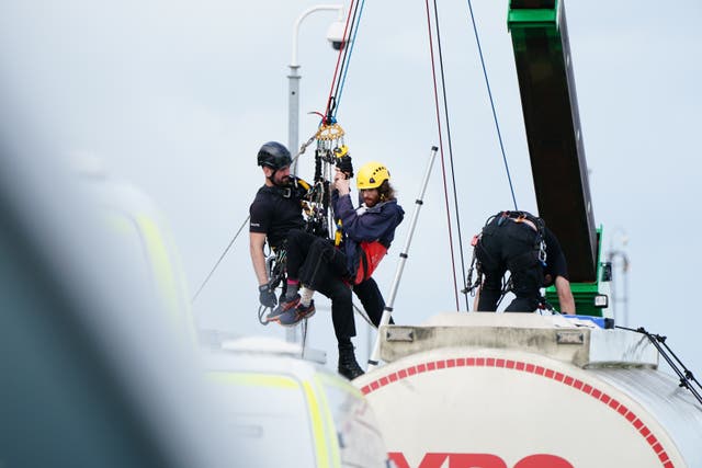 Police remove protesters from an oil tanker at the Ineos refinery in Grangemouth (Jane Barlow/PA)