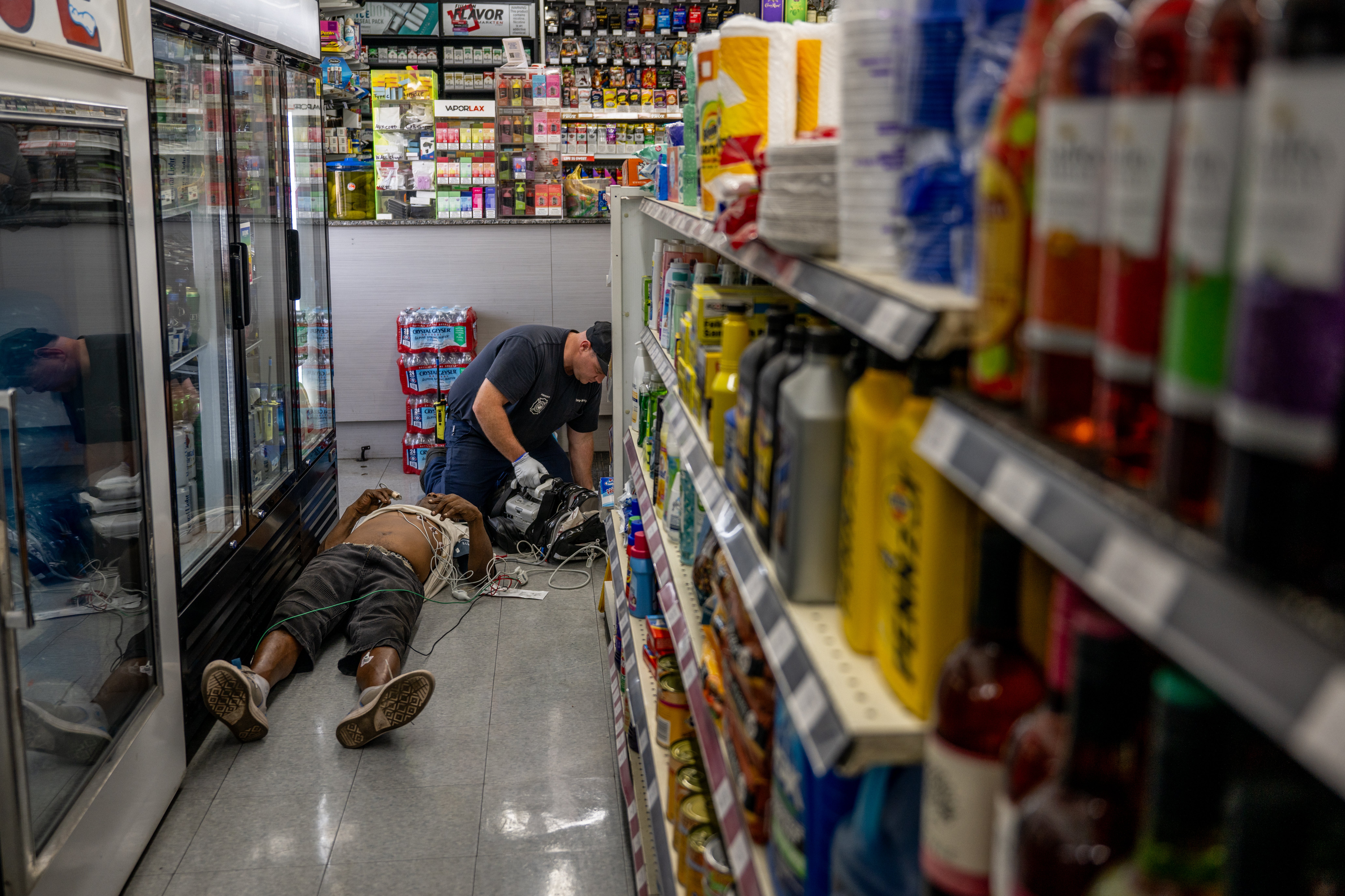 A person receives medical attention after collapsing in a convenience store on July 13, 2023 in Phoenix, Arizona. EMT was called after the person said they experienced hot flashes, dizziness, fatigue and chest pain
