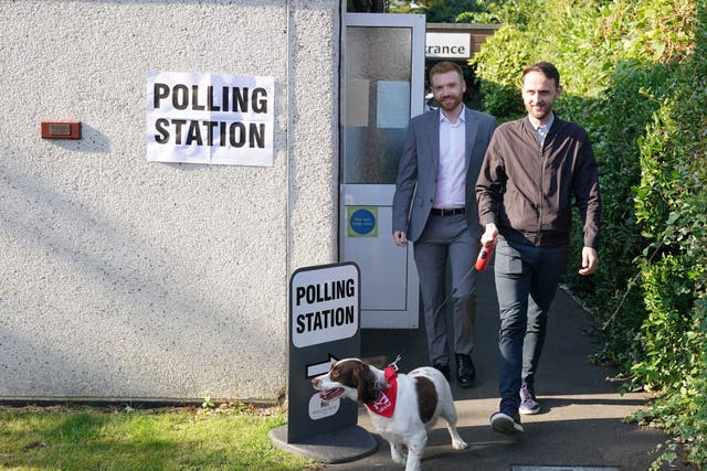 Danny Beales, Labour candidate for Uxbridge and South Ruislip (left) with his housemate Joel Kenyon and dog Buddy leave after casting their votes (Jonathan Brady/PA)