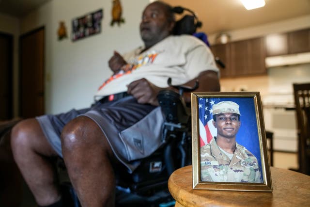 <p>A portrait of American soldier Travis King is displayed as his grandfather, Carl Gates, talks about his grandson </p>