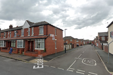 Woman, 50, dies in Manchester house fire after being pulled from window