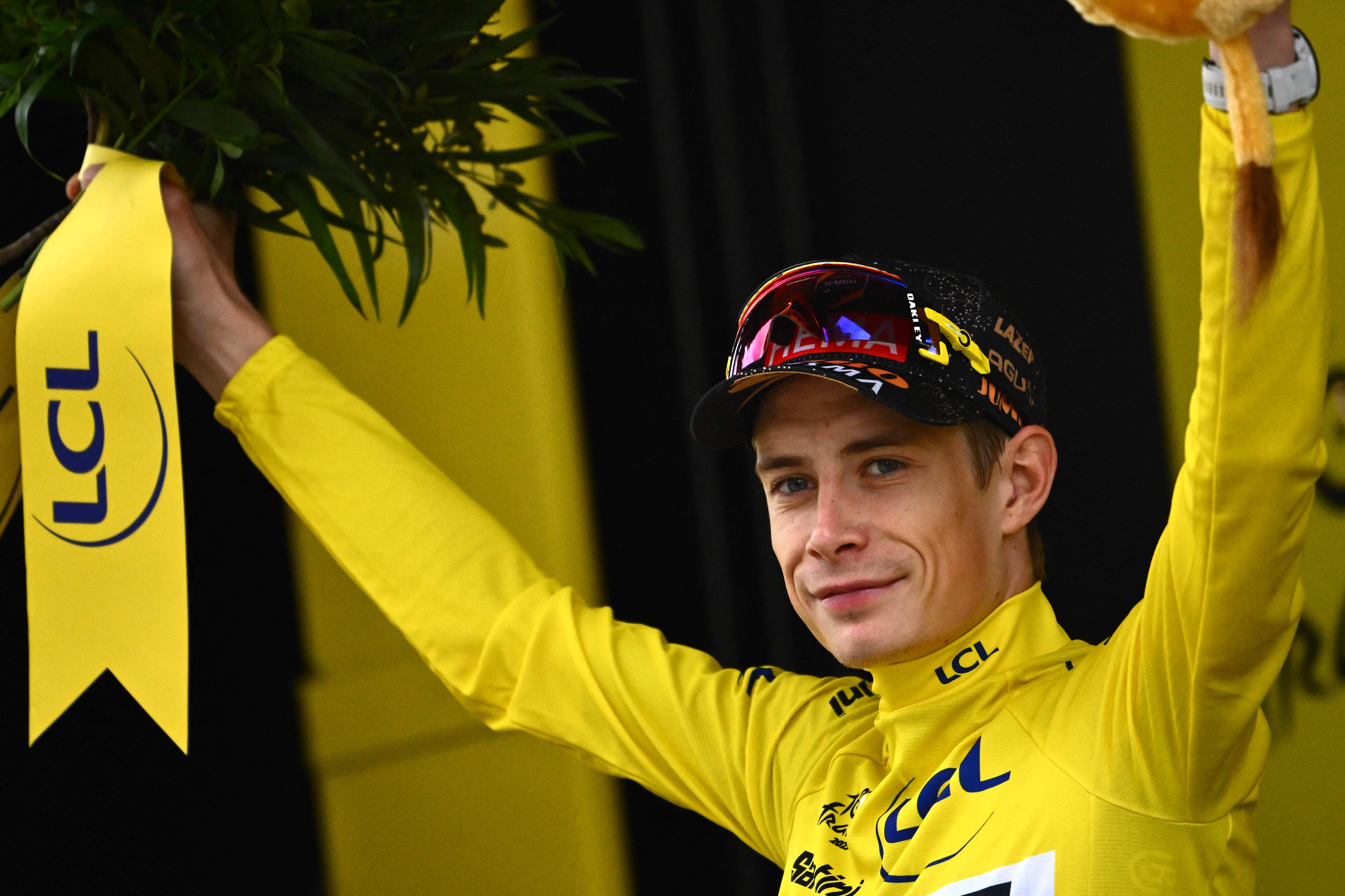 Jonas Vingegaard celebrates wearing the yellow jersey