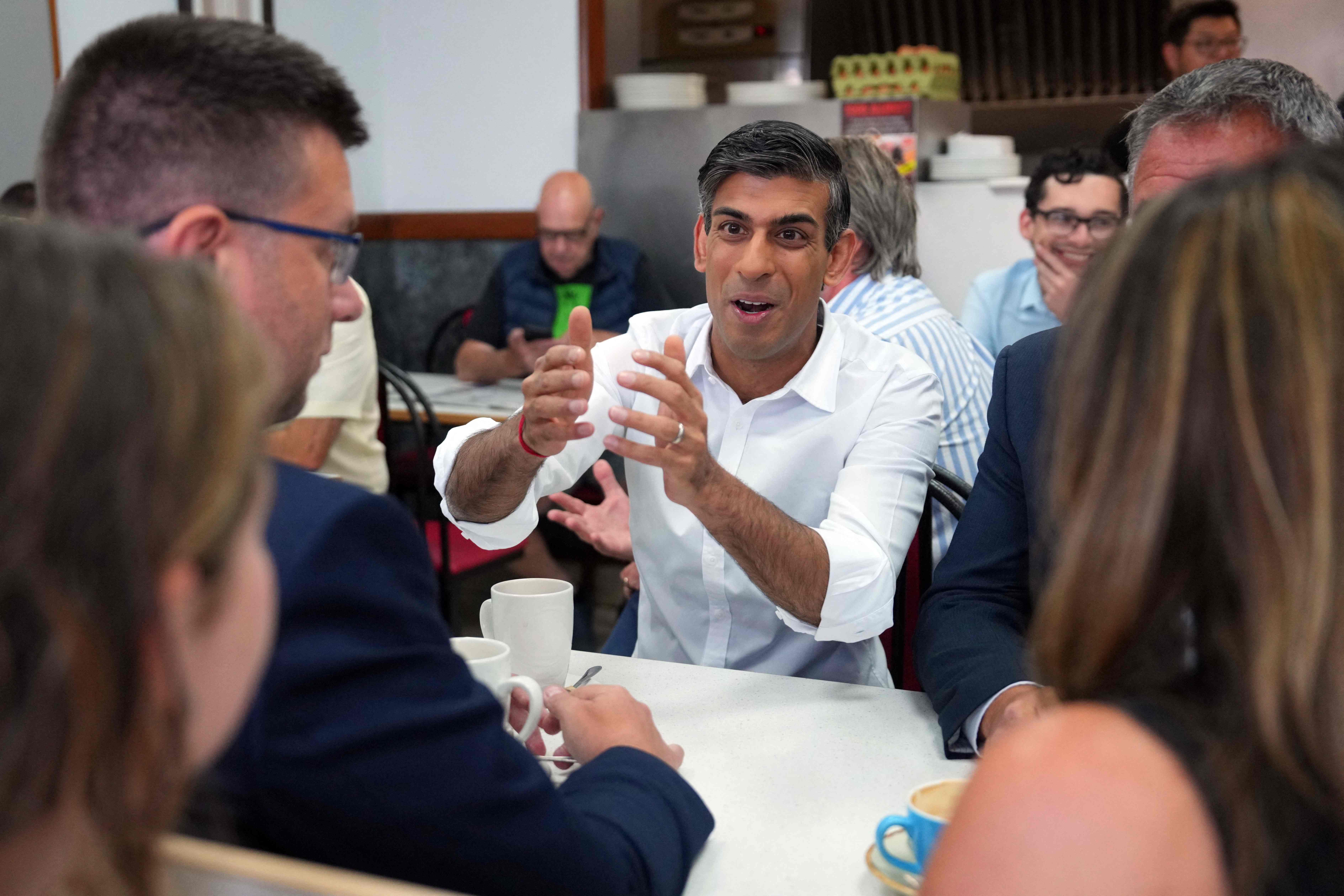 Rishi Sunak with Conservative party members and supporters at a cafe in the Uxbridge and Ruislip seat