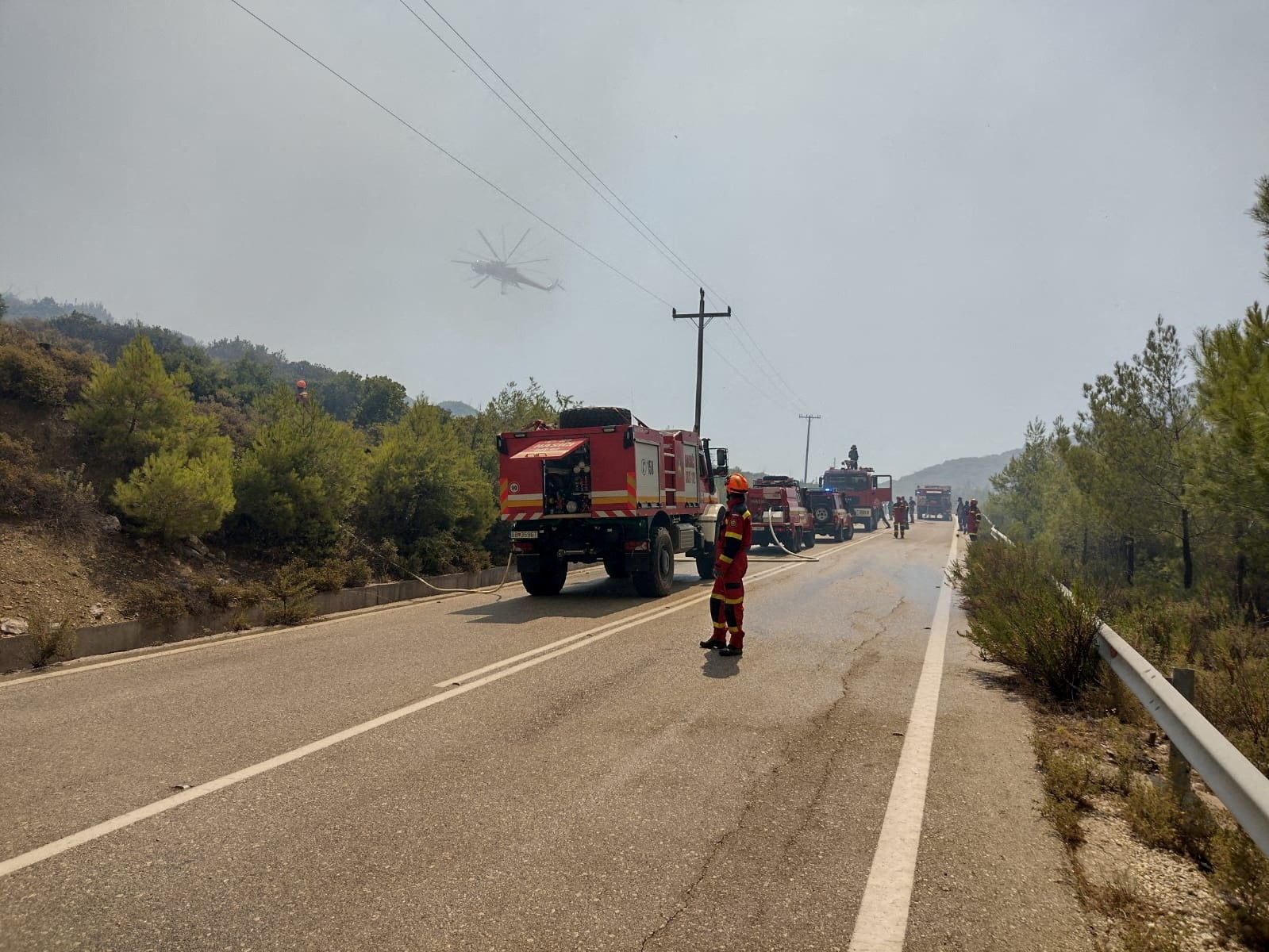 Firefighters try to extinguish a wildfire burning near Laerma, Rhodes Island