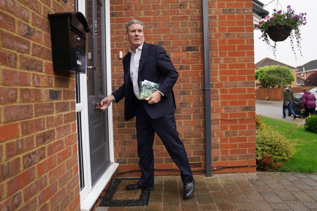Sir Keir delivered Labour flyers to a street of houses (Jacob King/PA)
