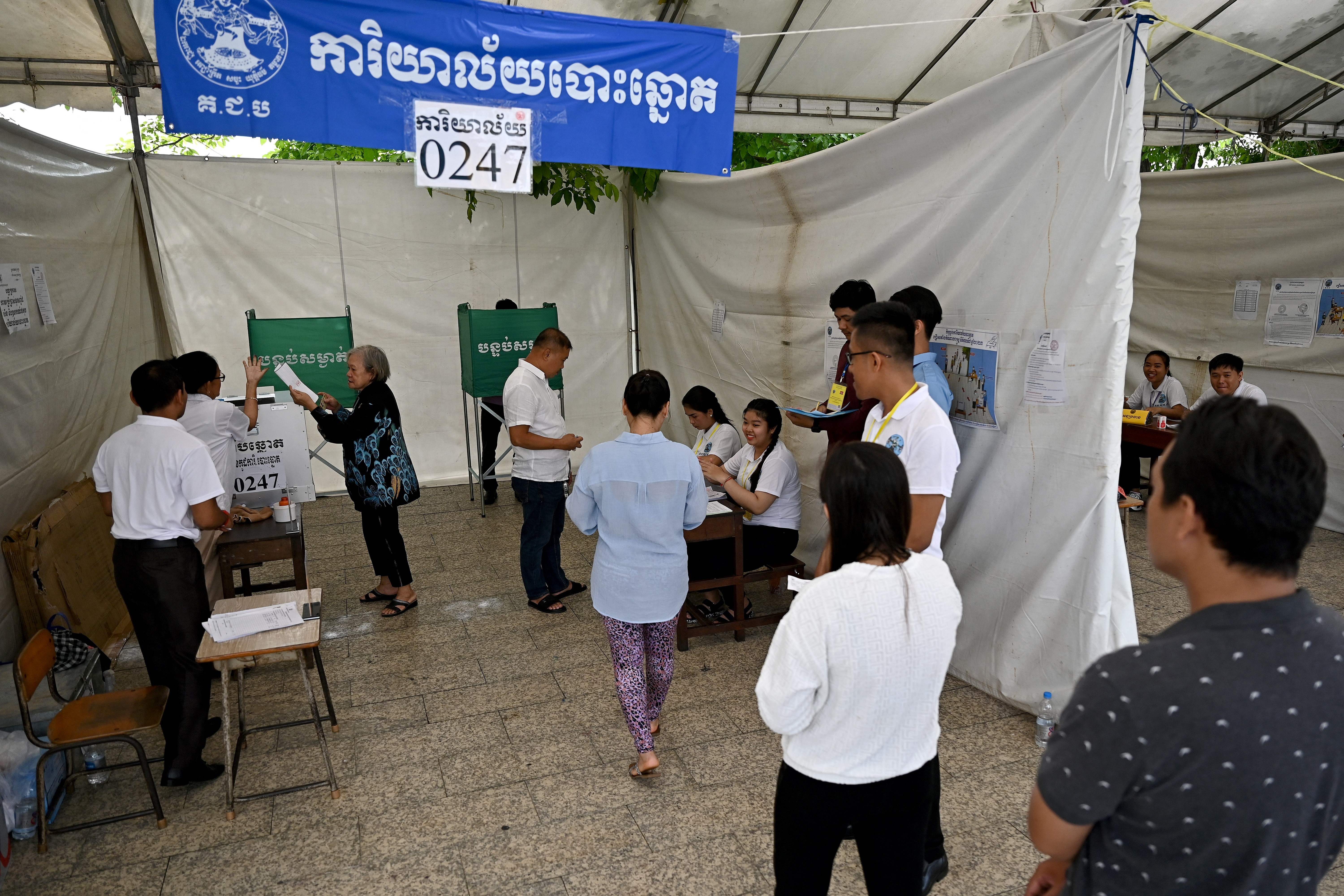 People line up to cast their votes at a polling station in Phnom Penh on 23 July, 2023 during the general elections
