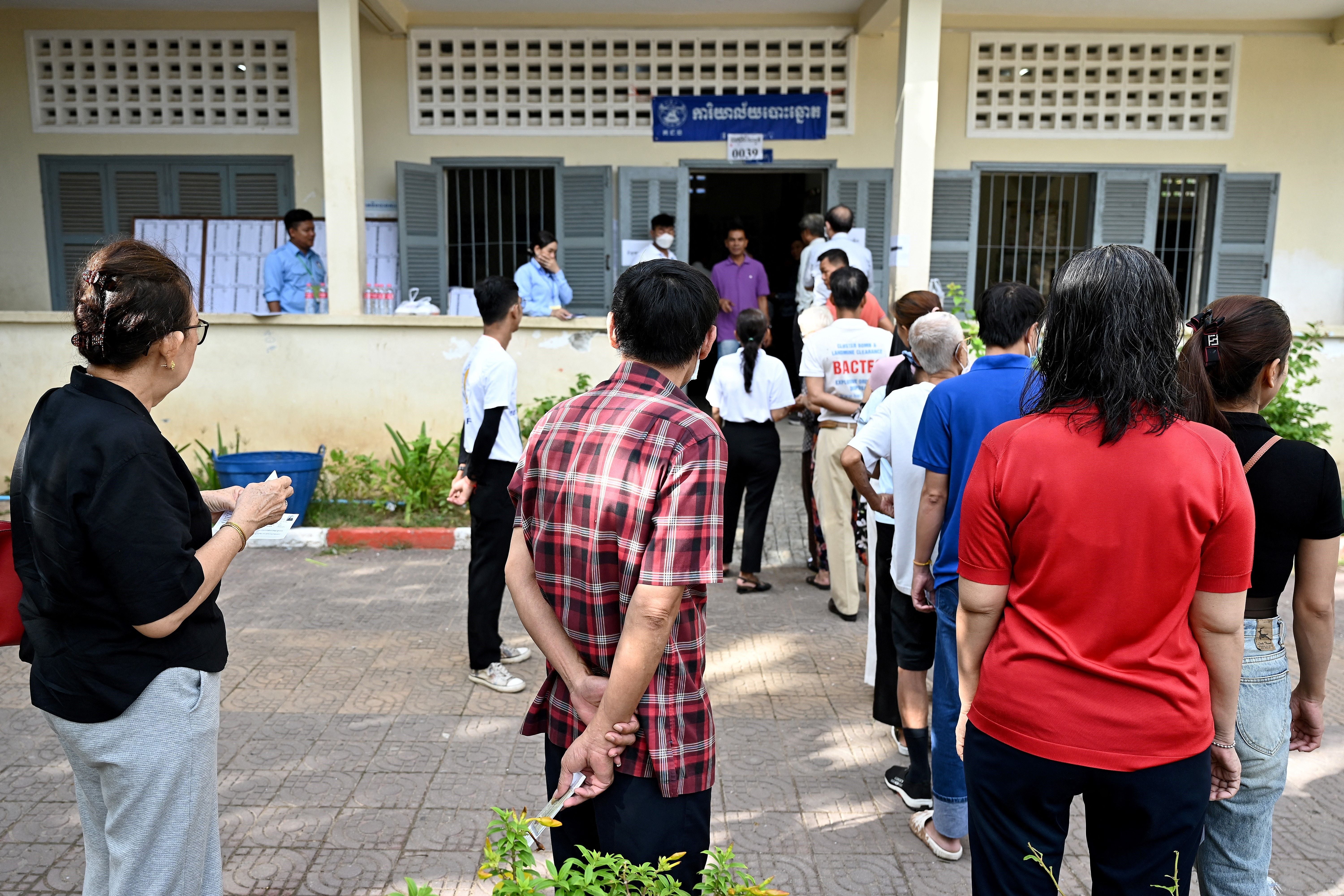 People line up to cast their votes at a polling station in Phnom Penh on 23 July, 2023 during the general election