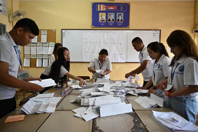 <p>Election officials count ballots at a polling station in Phnom Penh on 23 July, 2023 during the general elections</p>