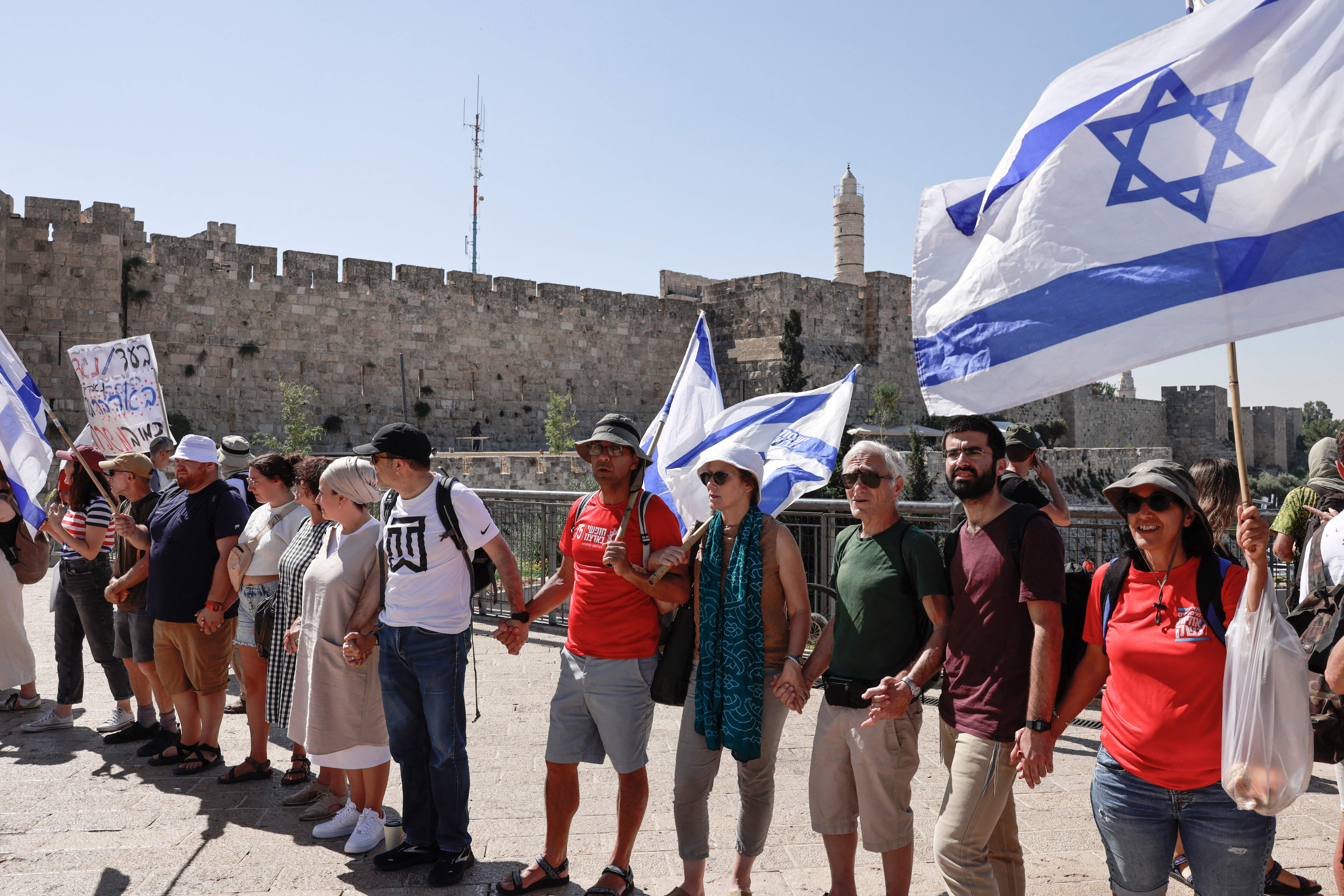 Protesters against the Israeli government’s judicial overhaul bill form a human chain in front of the Jaffa Gate in Jerusalem that will extend to reach the parliament on July 23, 2023, ahead of a vote