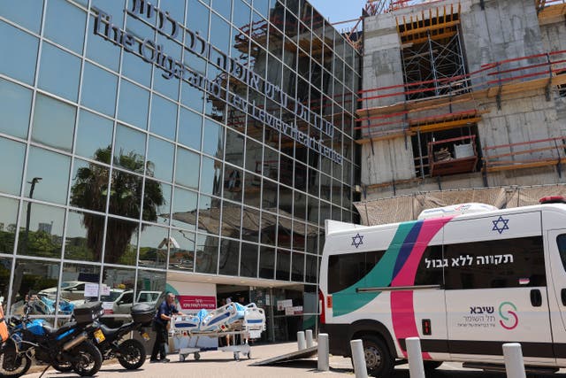 <p>A medic transports a patient to an ambulance in front of the Sheba Medical Centre in Ramat Gan where Israel’s Prime Minister Benjamin Netanyahu underwent surgery to implant a pacemaker on July 23, 2023</p>