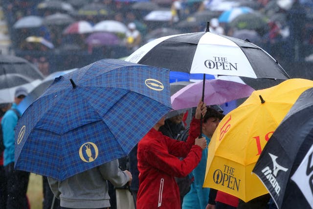Spectators with umbrellas as the rain falls during day four of The Open at Royal Liverpool (Peter Byrne/PA)
