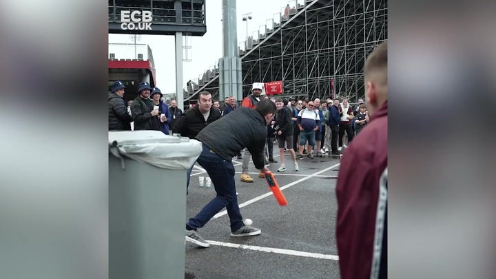 England fans play cricket outside Old Trafford as rain delays final day of the Ashes test match