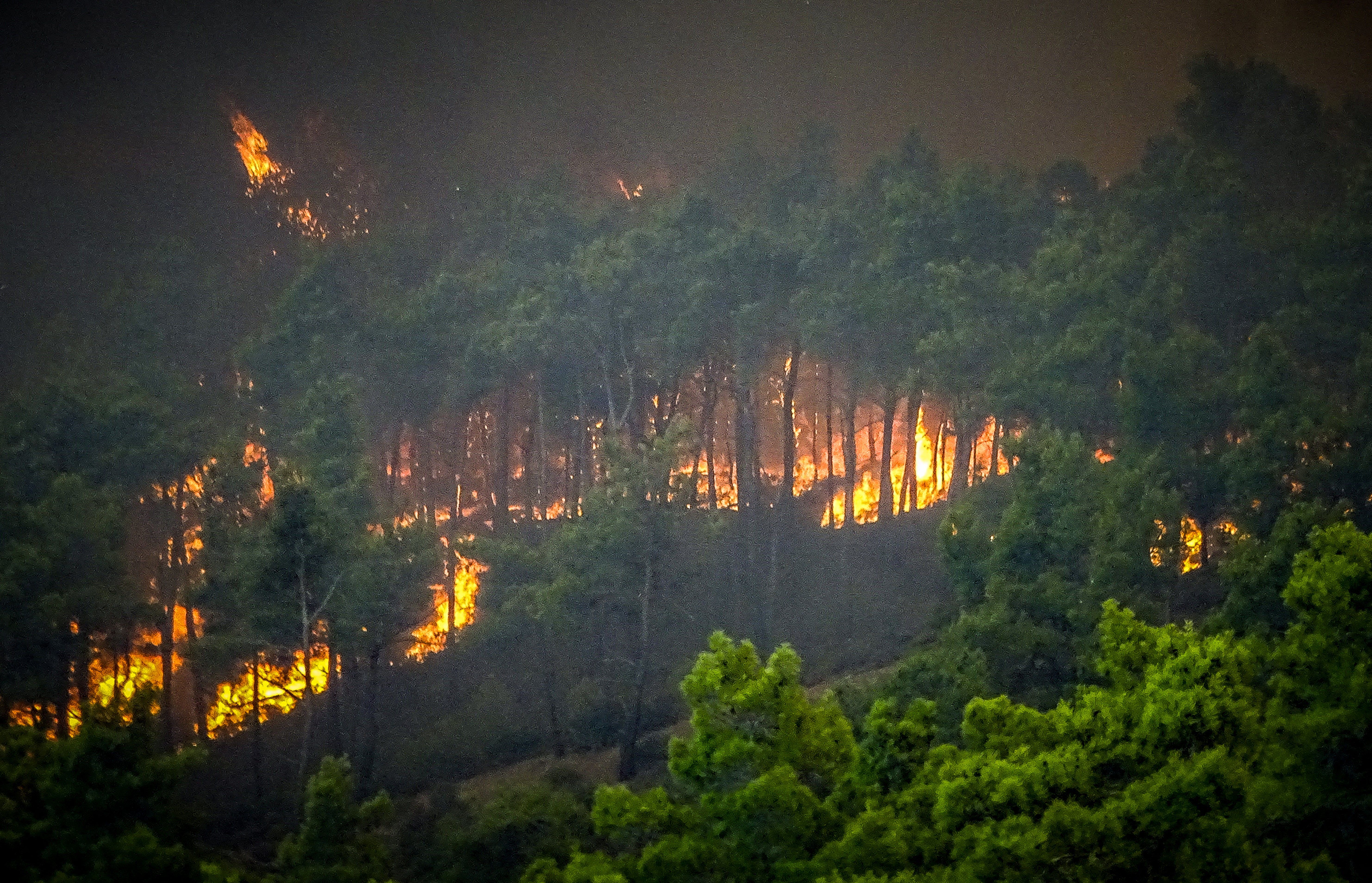 Smoke rises from a wildfire on the island of Rhodes