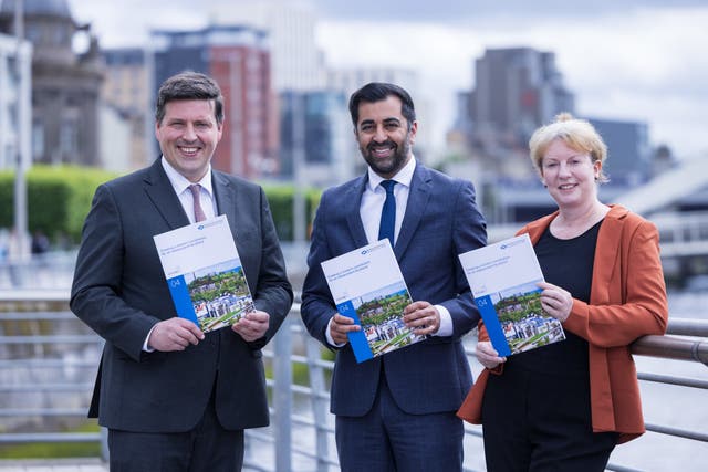 Jamie Hepburn, minister for independence, First Minister Humza Yousaf and Deputy First Minister Shona Robison pictured with a previous Building a New Scotland papers (Robert Perry/PA)