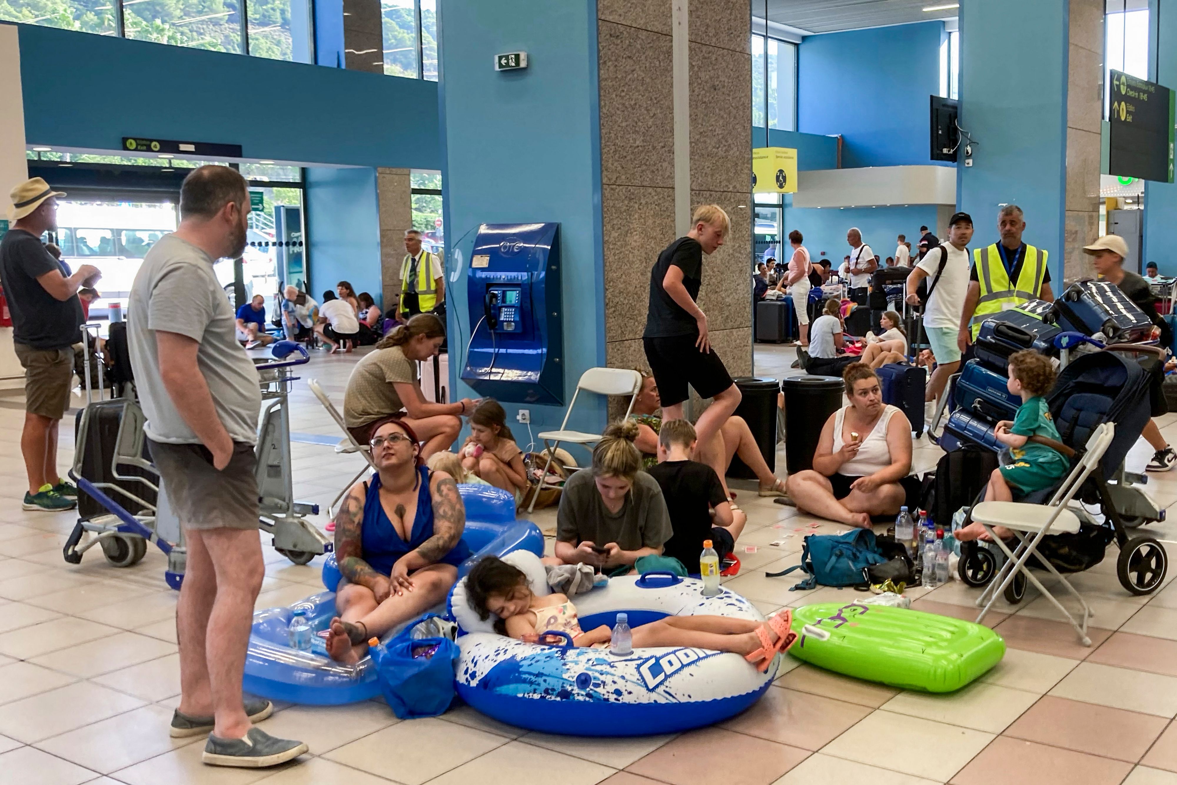 Tourists wait in Rhodes airport’s departure hall yesterday with evacuations under way