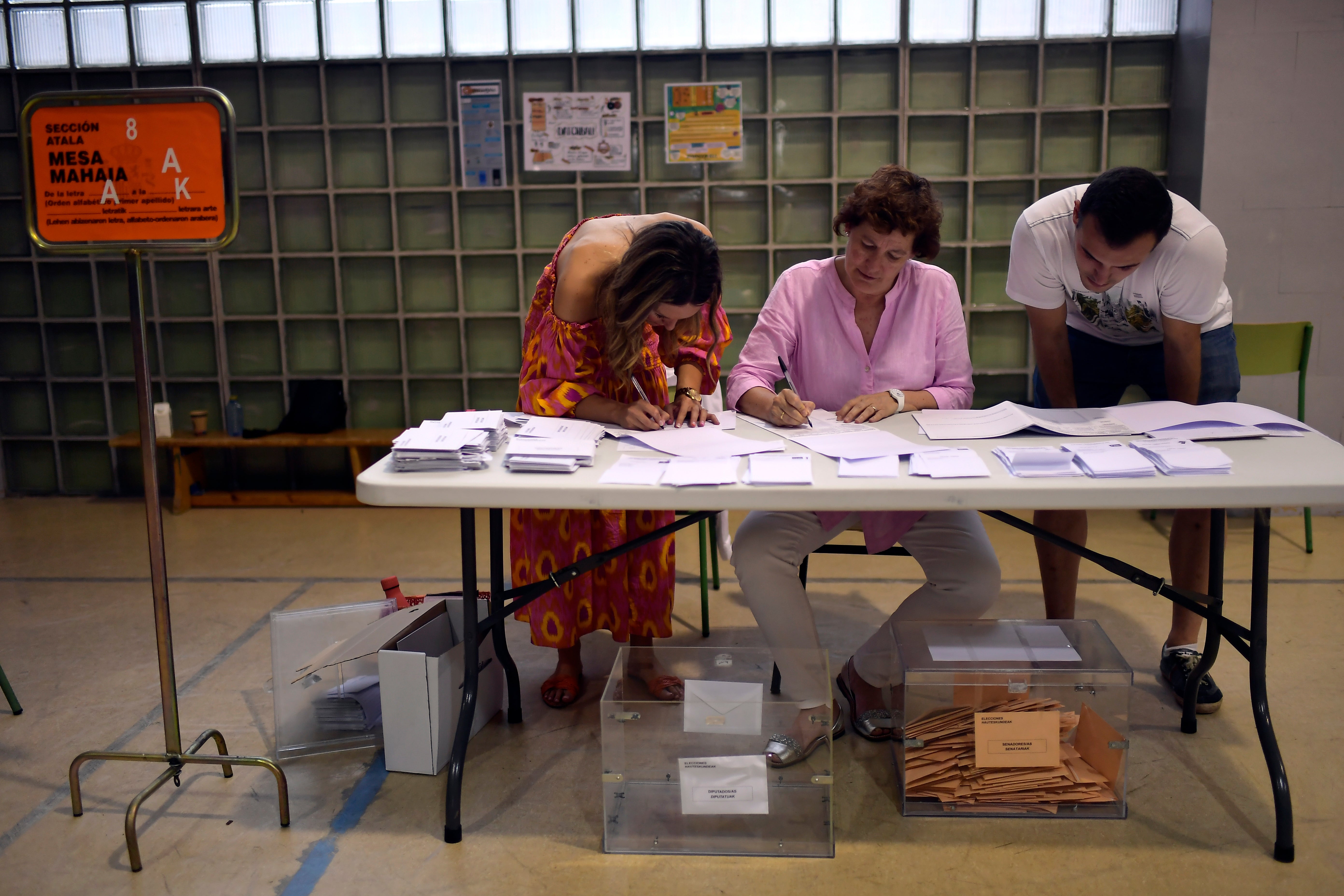 Election officials count ballots at a polling station in Pamplona, northern Spain