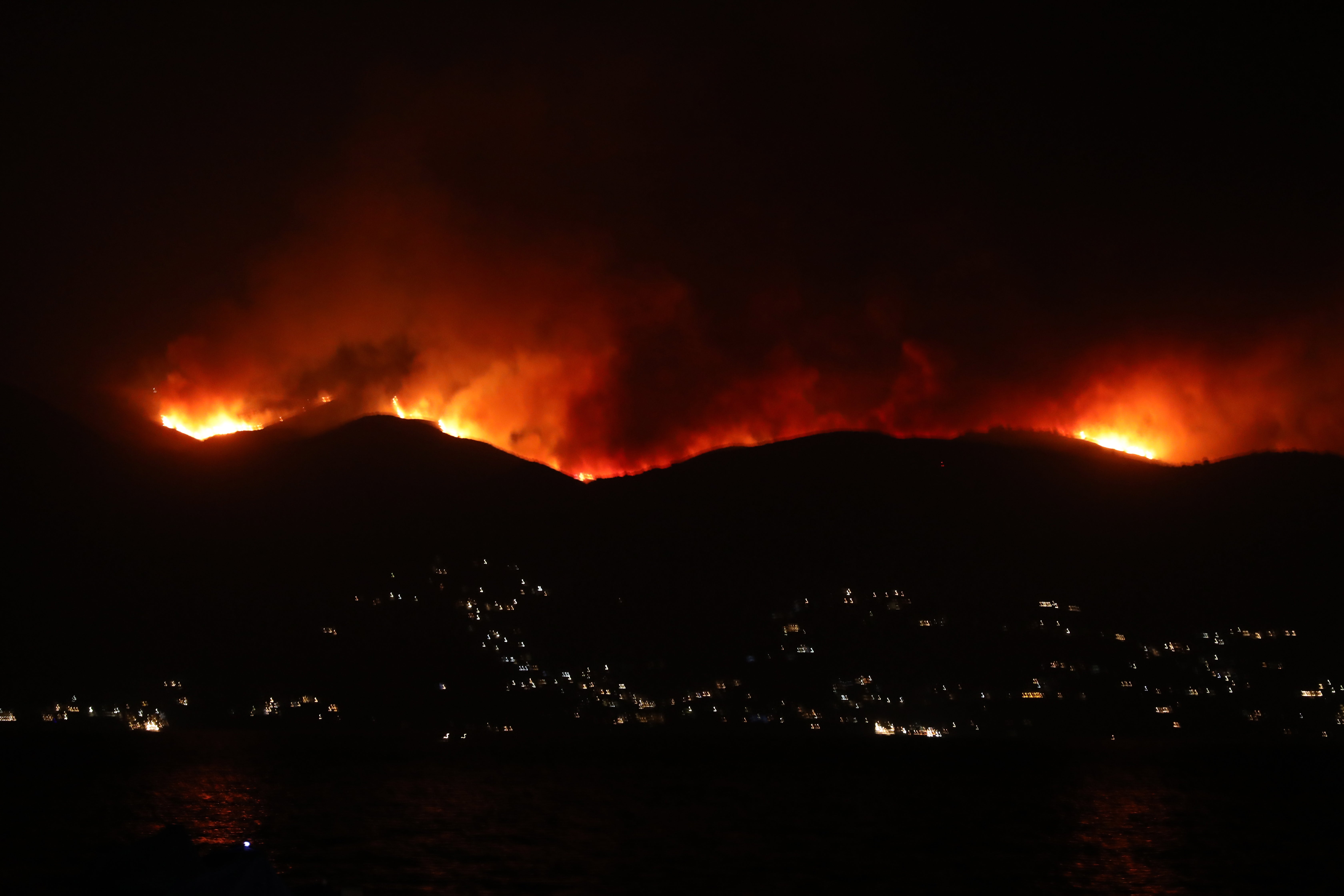 A fire burning on the Pantokratoras mountain on Corfu island, Greece