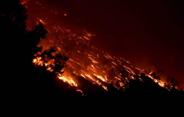 <p>A wildfire burns at the Trapeza village in Achaia Peloponnese, Greece, in July 2023 – the hottest month on record </p>