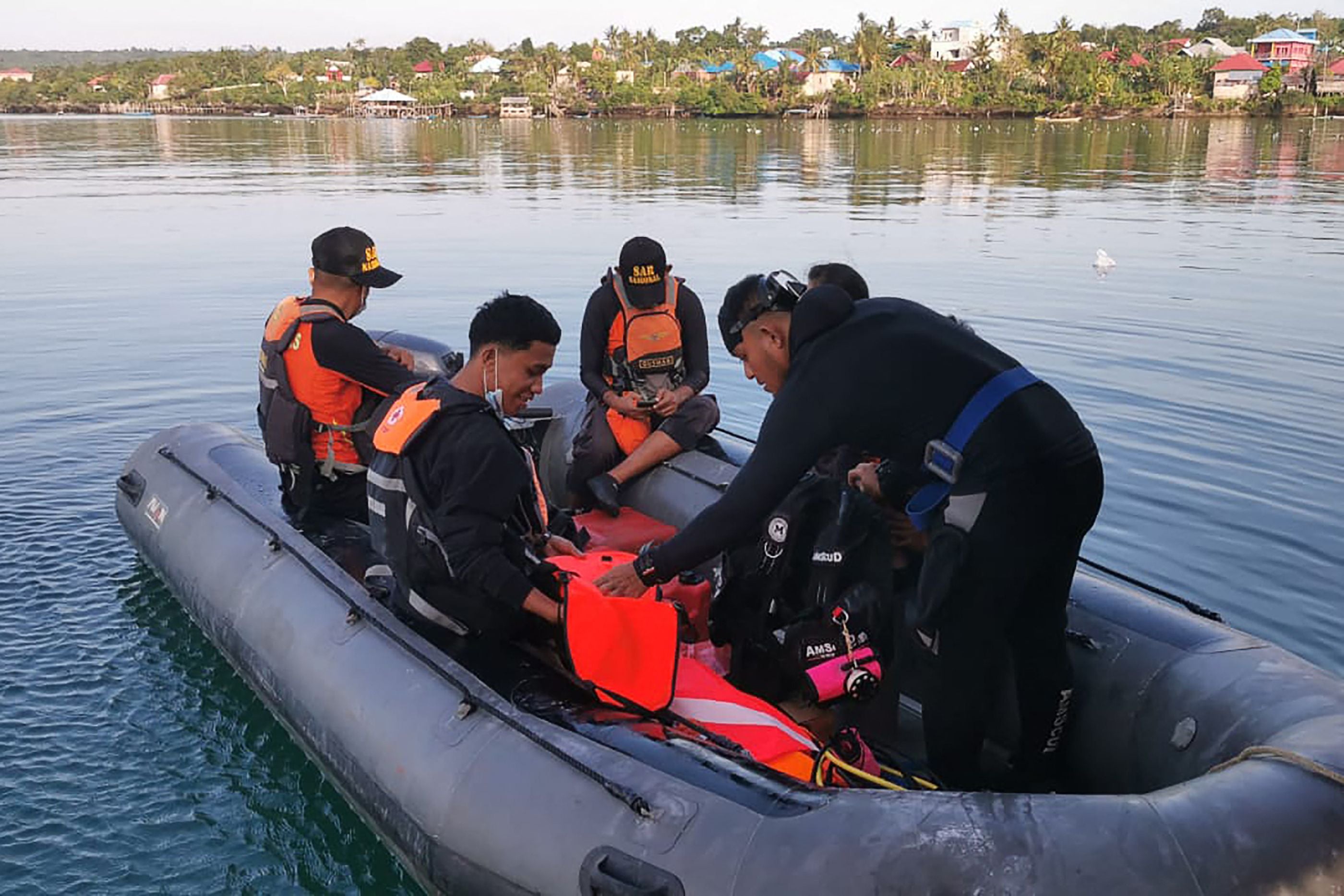 This handout photo from Indonesia’s National Rescue Agency (Basarnas) taken and released on 24 July 2023 shows members of a rescue team setting out to conduct search and rescue operations in Buton Tengah, southwest Sulawesi after a ferry sank
