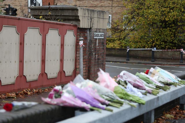 Floral tributes left near the scene where a tram crashed, killing seven people, in Croydon, south London (Steve Parsons/PA)