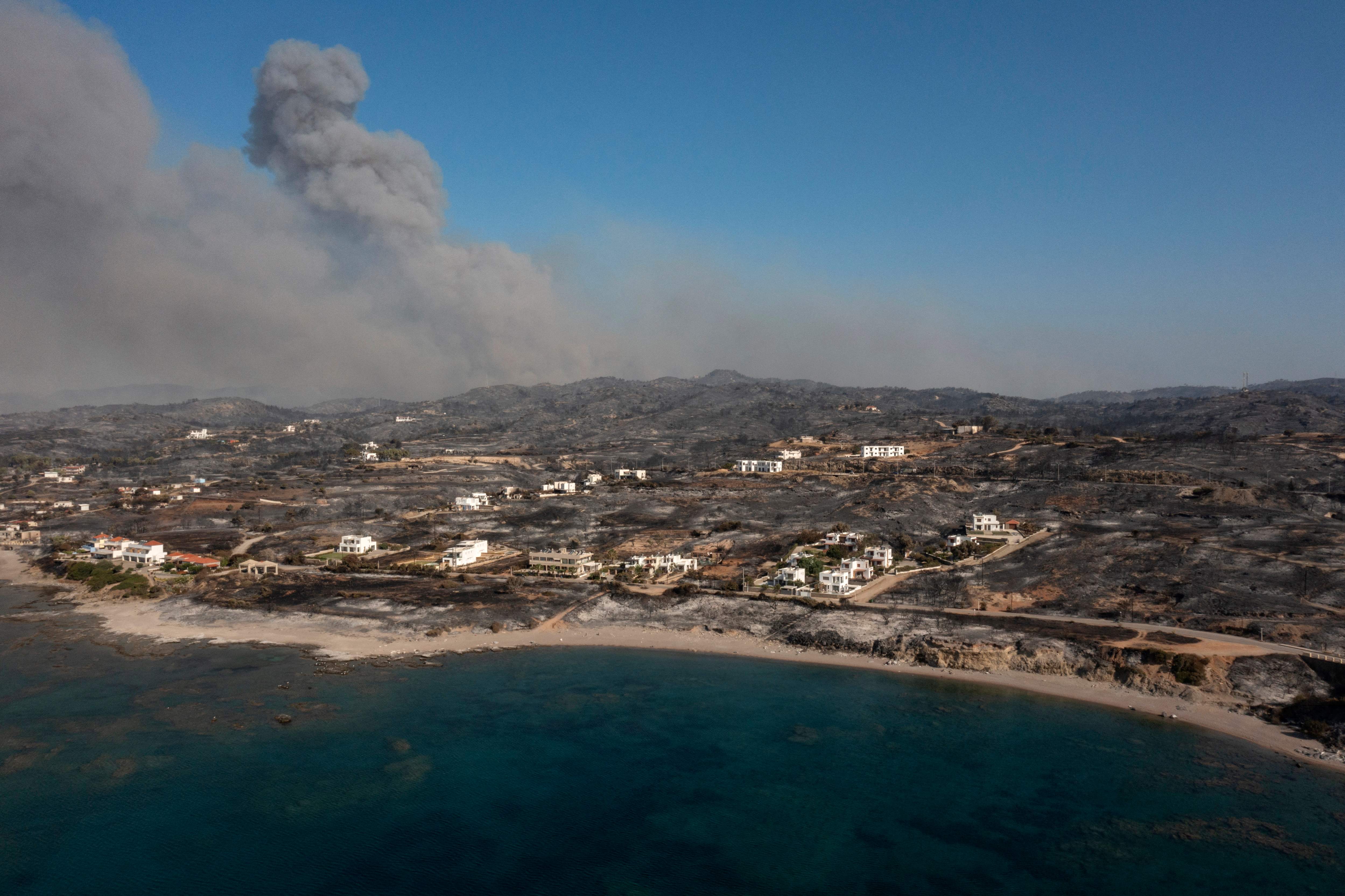 An aerial view shows smoke billowing behind Kiotari village, on the island of Rhodes