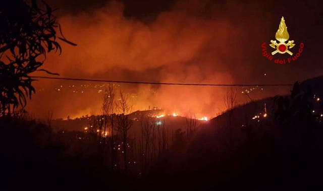 <p>Flames and smoke rise as a wildfire burns near the Sicilian village of Curcuraci near Messina, Italy</p>
