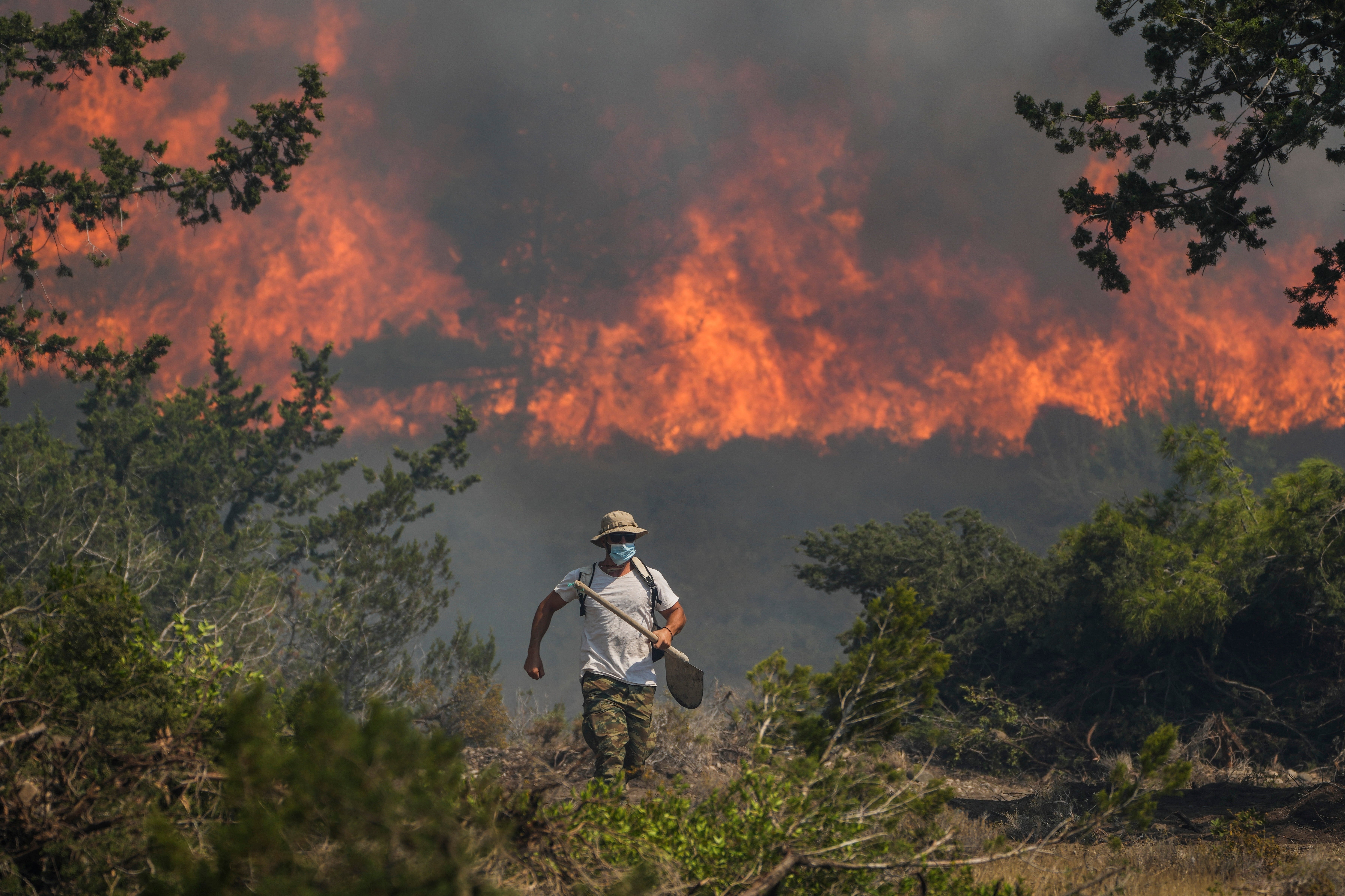 Flames burn a forest in Vati village on the Aegean Sea island of Rhodes