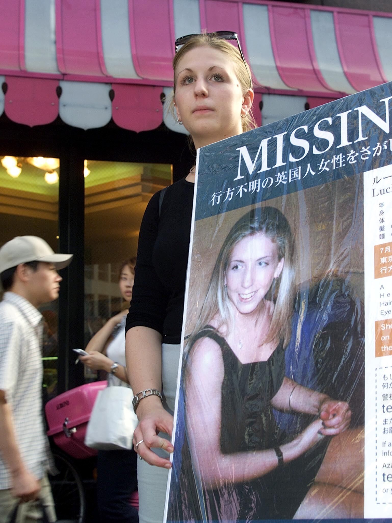 Lucie’s sister, Sophie, holds her missing poster