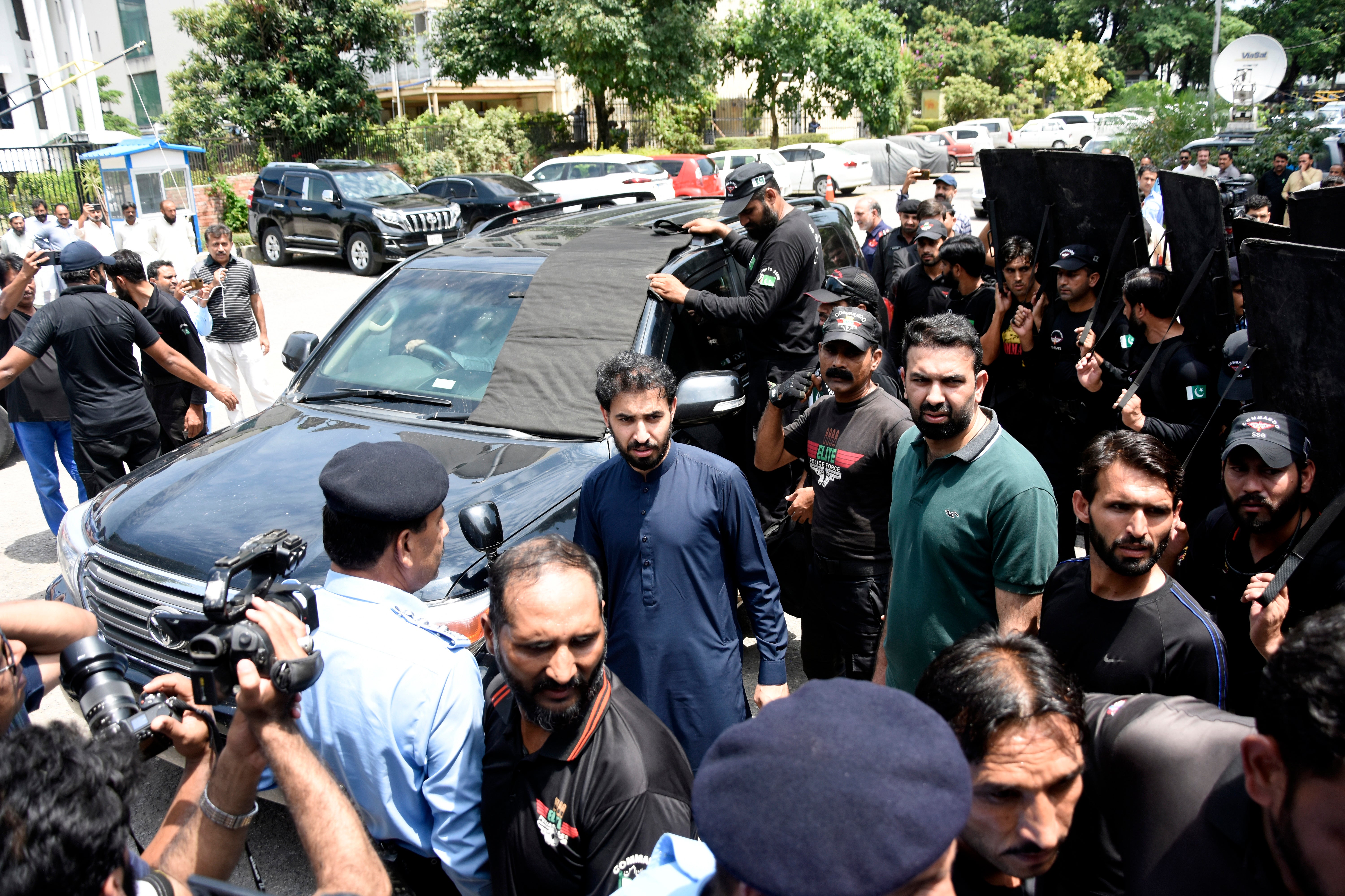 A vehicle carrying Imran Khan arrives for a hearing at the Election Commission of Pakistan, in Islamabad