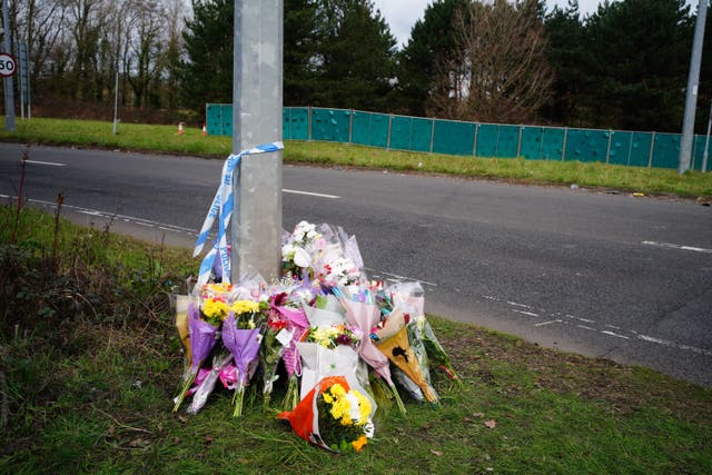 Floral tributes left near the scene in the St Mellons area of Cardiff where three people died in a road traffic accident. A man has been charged with driving offences as part of the police inquiry (PA Wire)