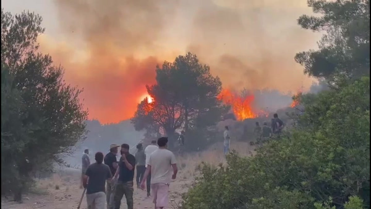 Rhodes residents join wildfire fight with shovels, tree branches and towels