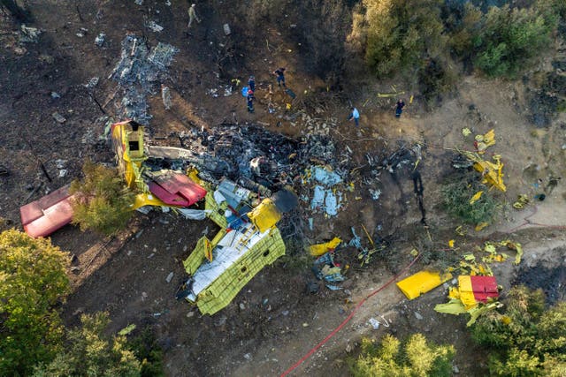 <p>Rescuers operate at the site where a firefighting plane crashed after a water drop as a wildfire burns in Karystos on the island of Evia, Greece</p>