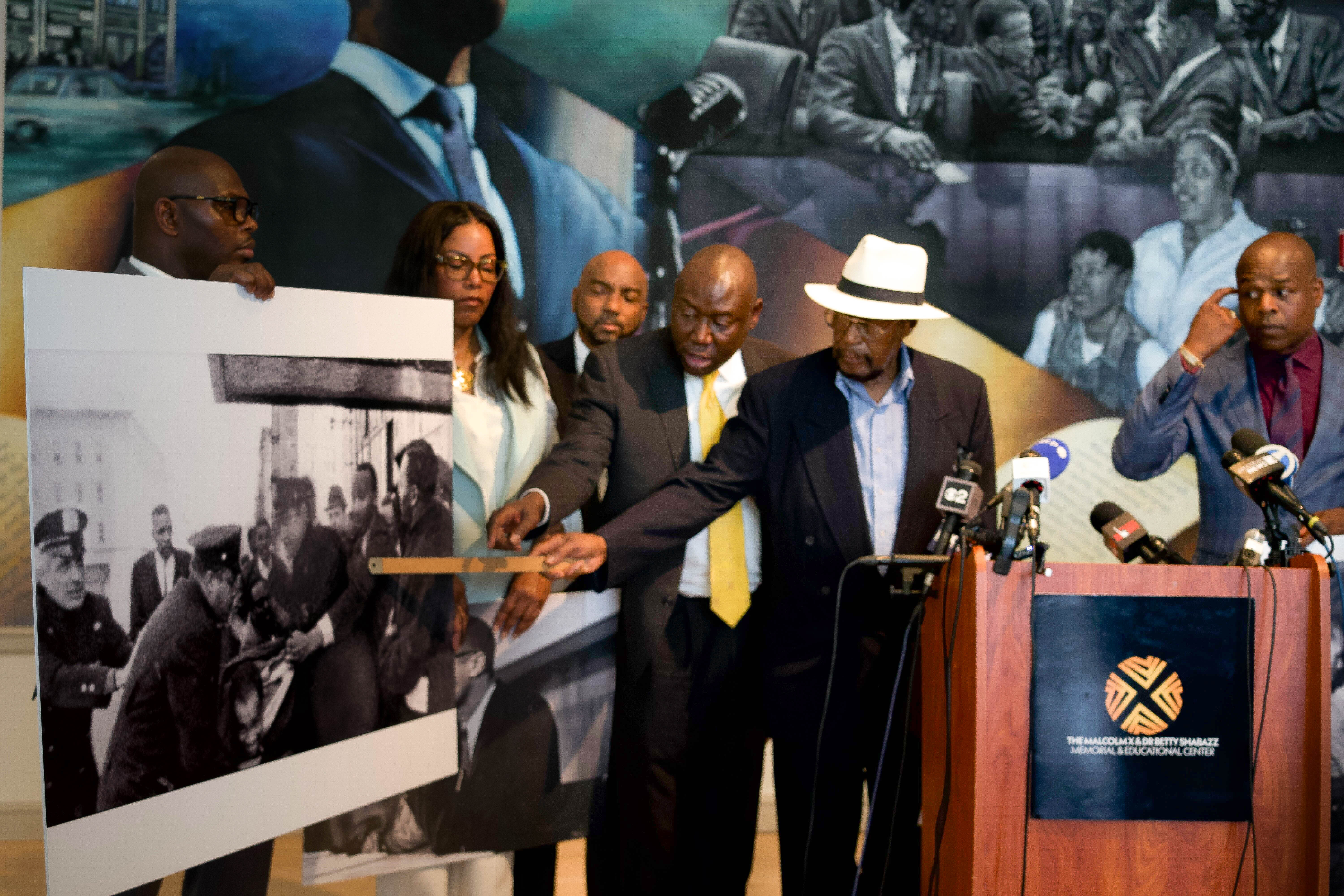 Mustafa Hassan points to himself in a photo from the day Malcolm X was assassinated