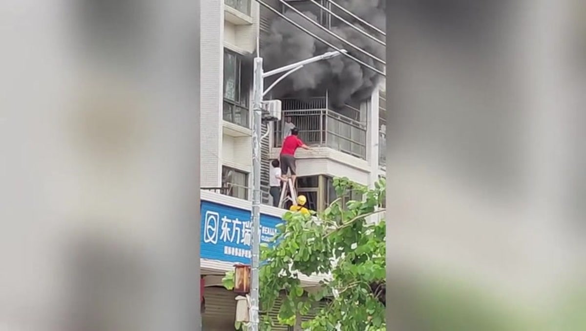 Toddler rescued from balcony as massive fire rages inside apartment