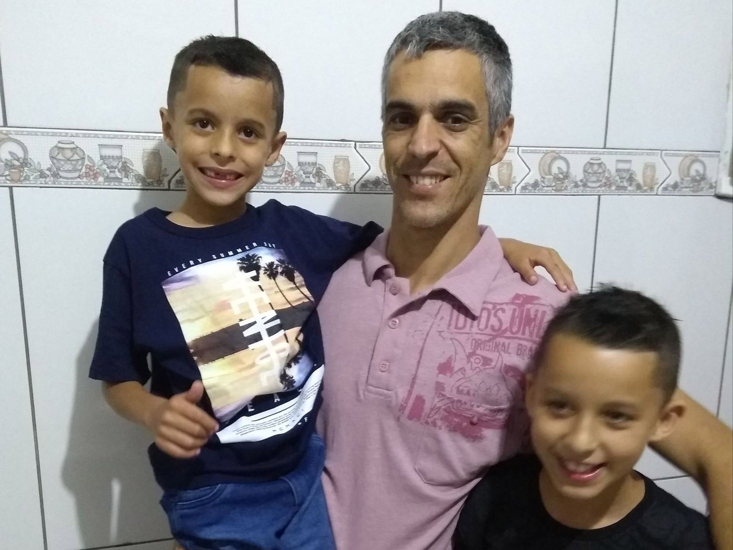 Gustavo Bernardo Leal, 15, and Gabriel Bernardo Leal, 11, are pictured with their father