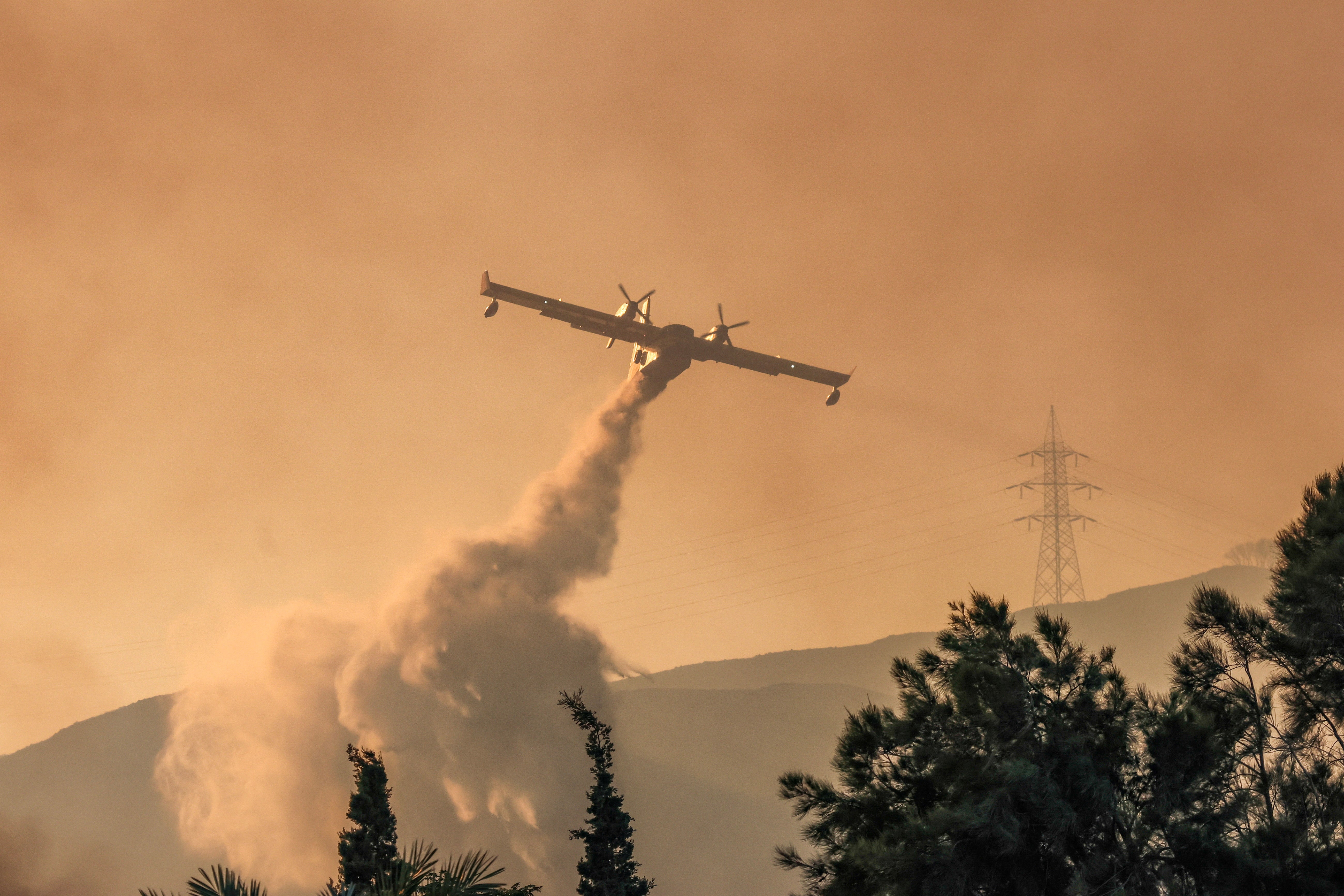 A firefighting plane was seen dropping water over the village of Gennadi in Rhodes