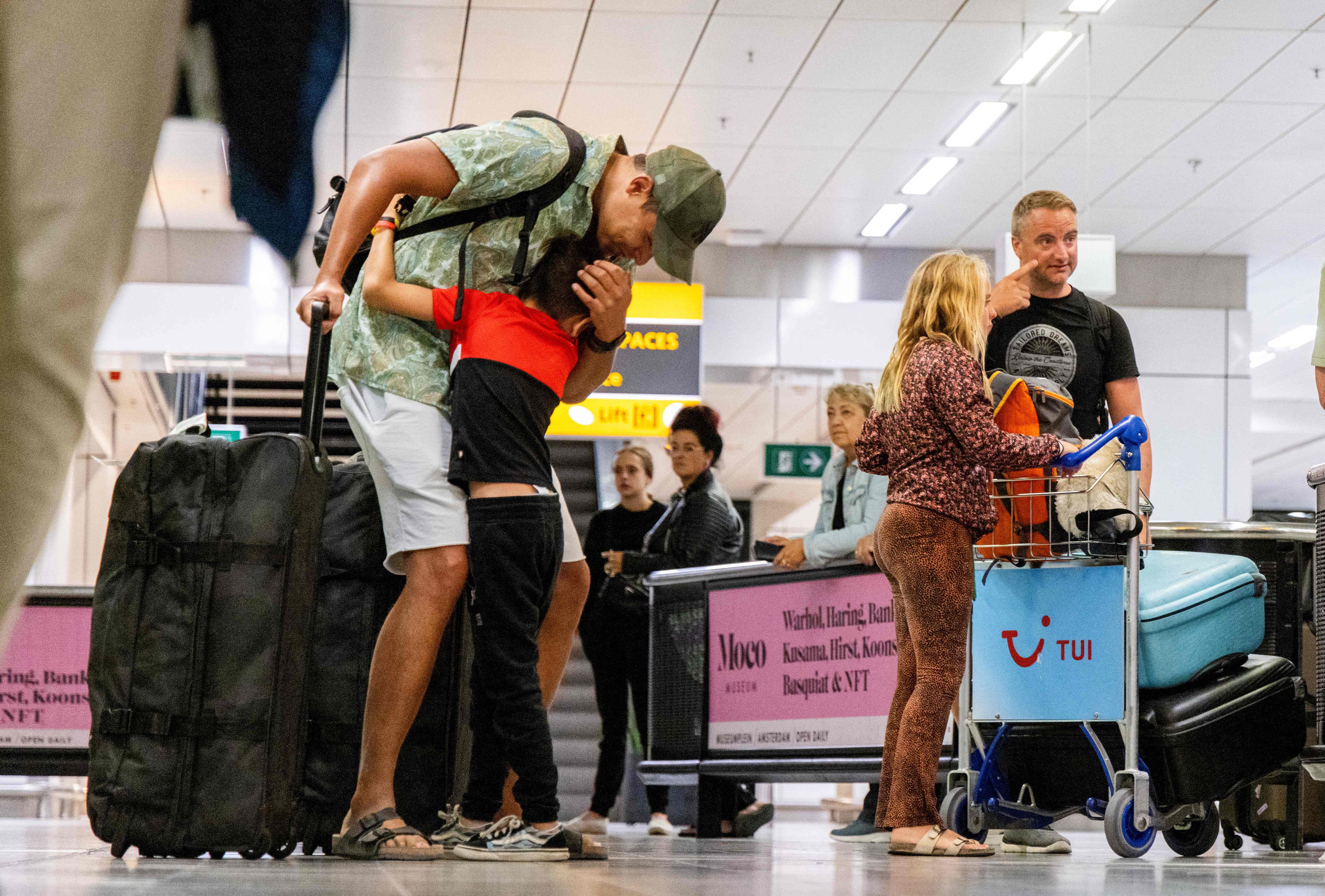 Holidaymakers arrive after returning from Rhodes where evacuations were taking place on 24 July