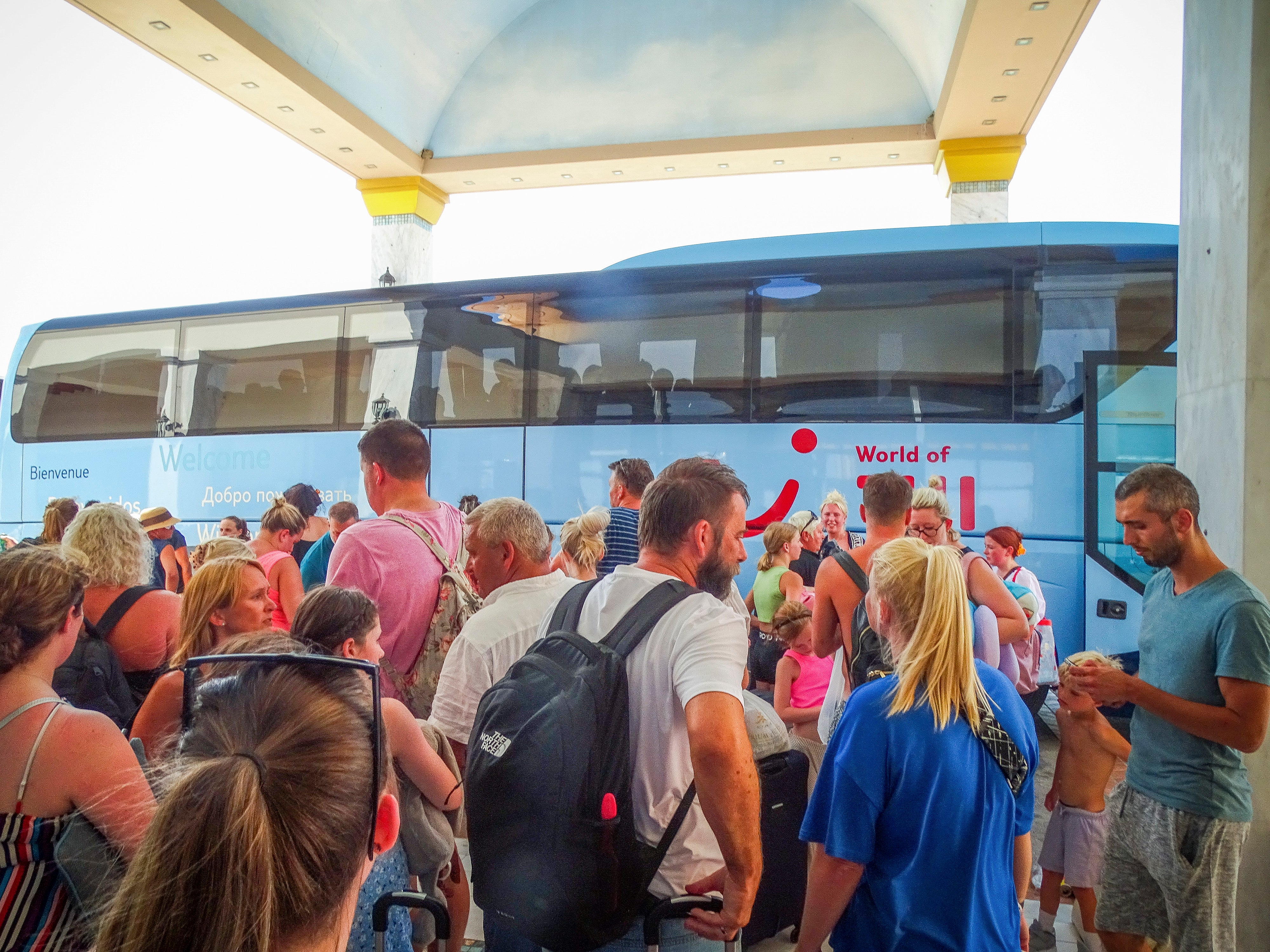 Evacuees wait to board on buses as they leave their hotel during a forest fire in Rhodes