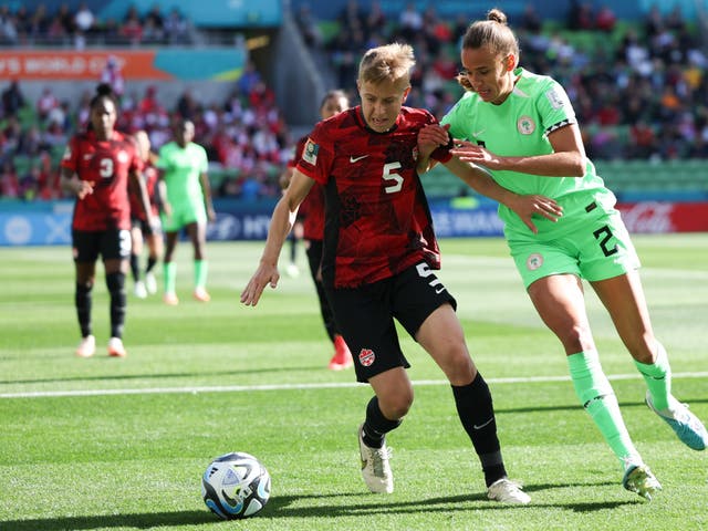 <p>Canada’s Quinn and Nigeria’s Ashleigh Plumptre battle for the ball during the Women’s World Cup opening Group B match in Melbourne, Australia, on Friday 21 July 2023</p>