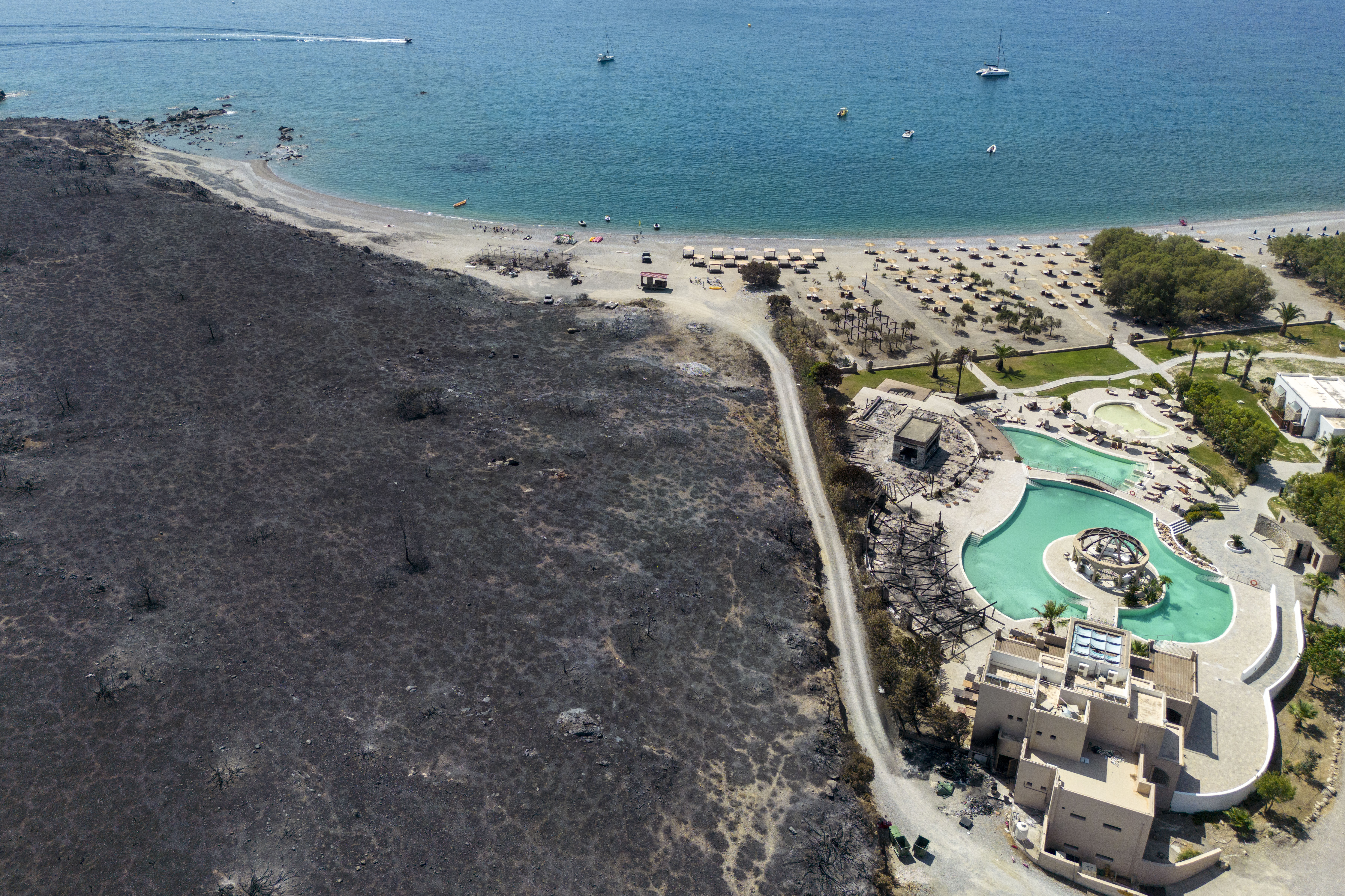 Wildfires have scorched the ground in the resort village of Kotari in Greece