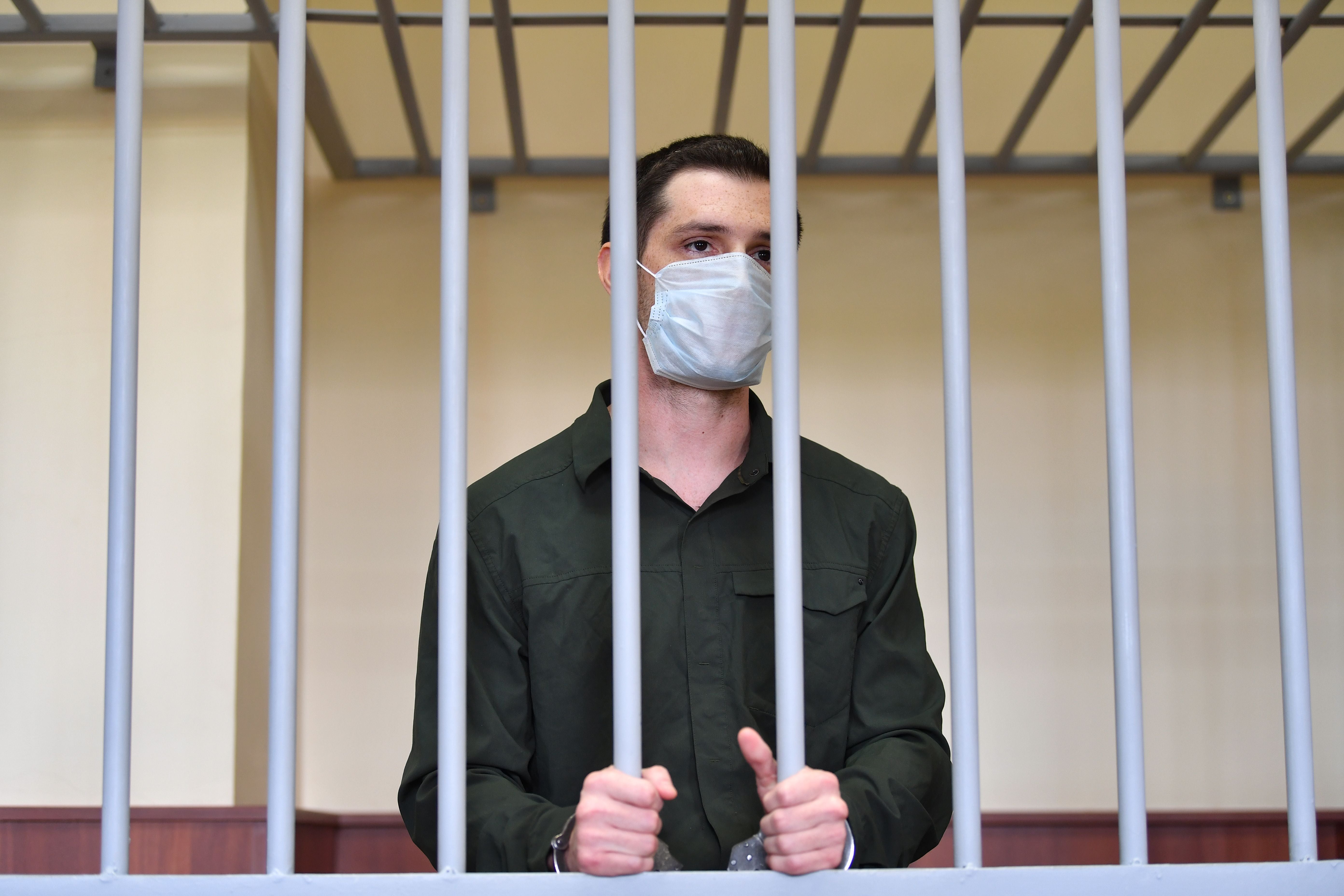 Mr Reed was charged with attacking police and is pictured standing inside a defendants’ cage during his verdict hearing at Moscow’s Golovinsky district court on 30 July 30