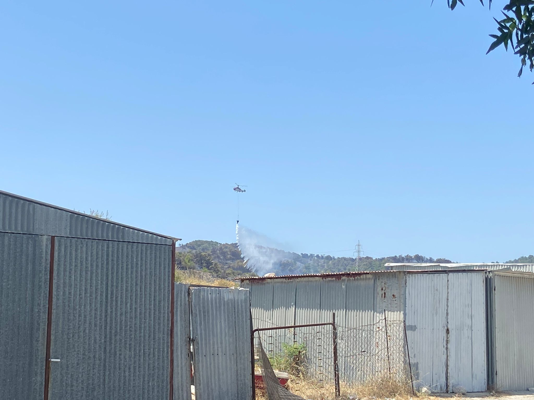 A firefighting plane drops water on a flare-up near Malonas, Rhodes