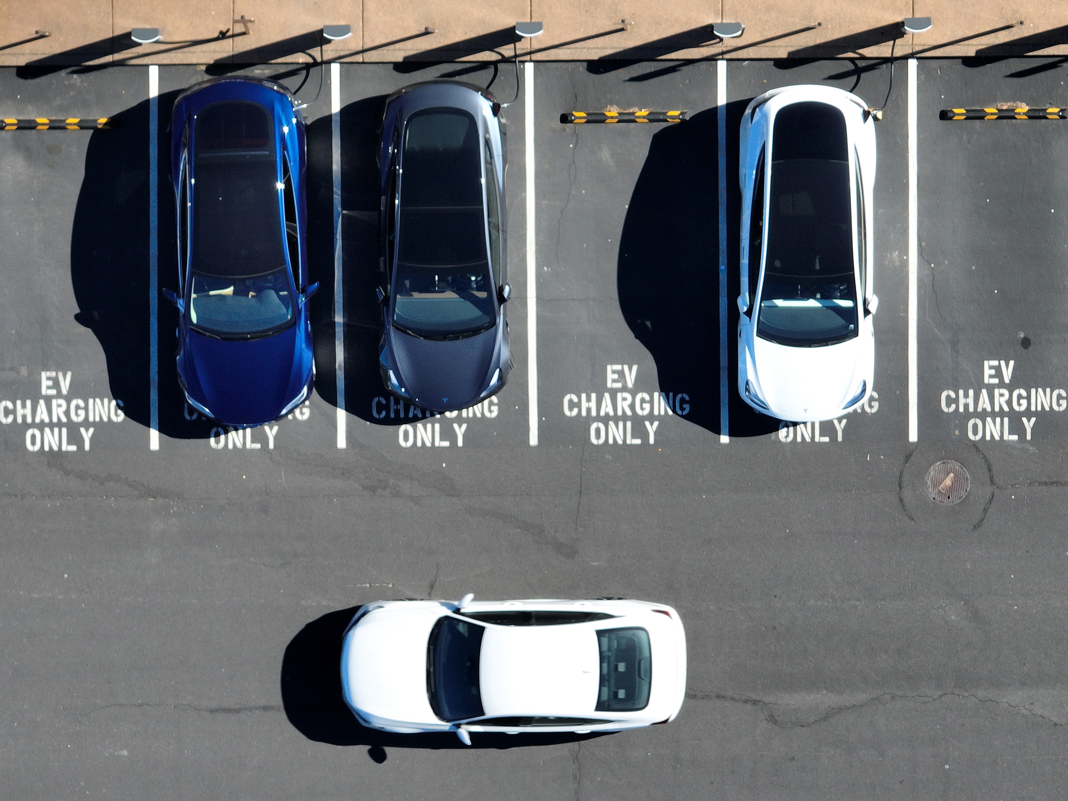Electric cars recharge at a Tesla charger station on 15 February, 2023 in Corte Madera, California