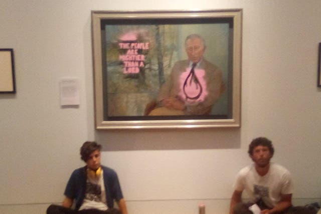 Two activists from This Is Rigged painted over a portrait of The King on Wednesday at the Scottish National Portrait Gallery on Wednesday (This Is Rigged/PA)