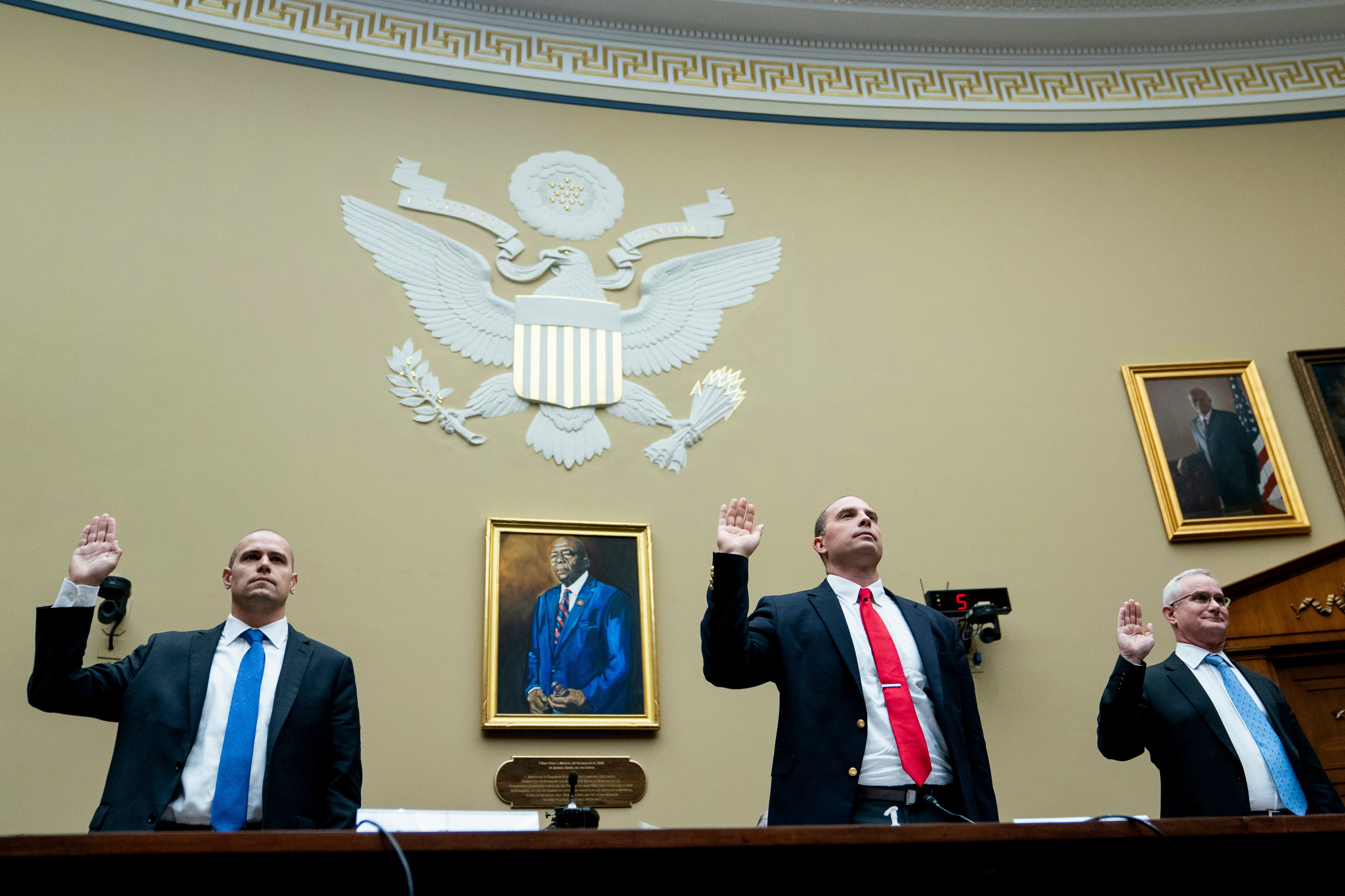 Ryan Graves, Americans for Safe Aerospace Executive Director, from left, U.S. Air Force (Ret.) Maj. David Grusch, and U.S. Navy (Ret.) Cmdr. David Fravor, are sworn in during a House Oversight and Accountability subcommittee hearing on UFOs, Wednesday, July 26, 2023, on Capitol Hill in Washington.